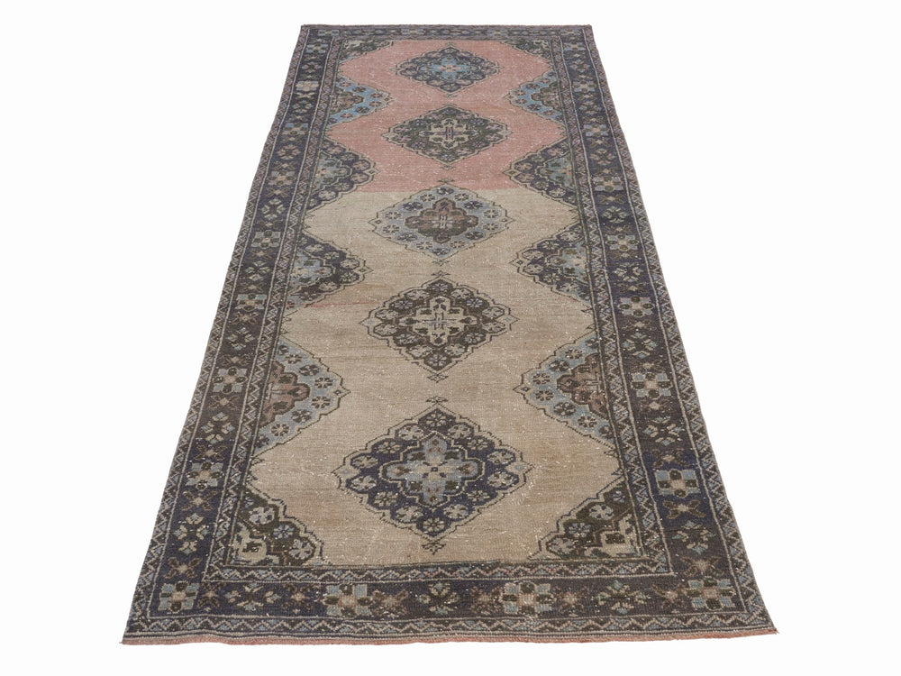 Anatolian runner with repeating medallions on a muted pink and taupe field