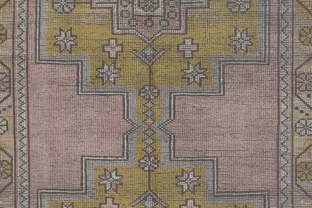Blotting a vintage wool rug by hand with a white cloth