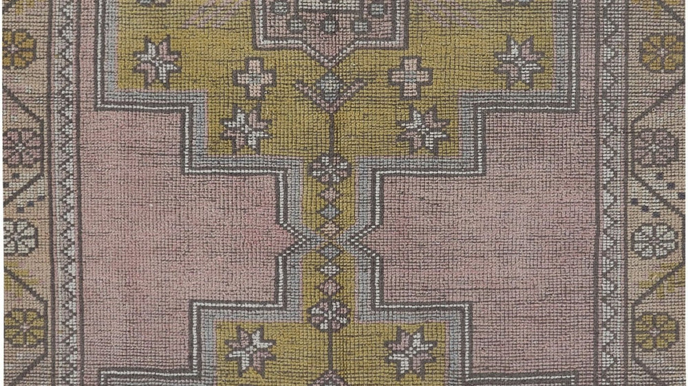 Window light falling across a vintage rug, showing abrash