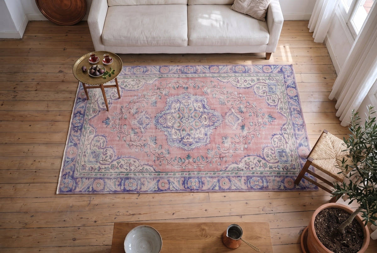 A soft pink vintage Turkish Manisa rug in an Istanbul apartment overlooking the Bosphorus, seen from above