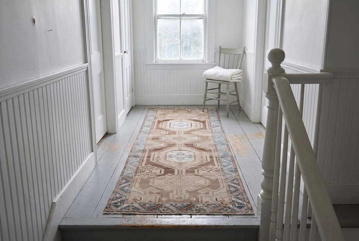A soft taupe vintage Persian Saveh runner on the upstairs landing of a Maine farmhouse