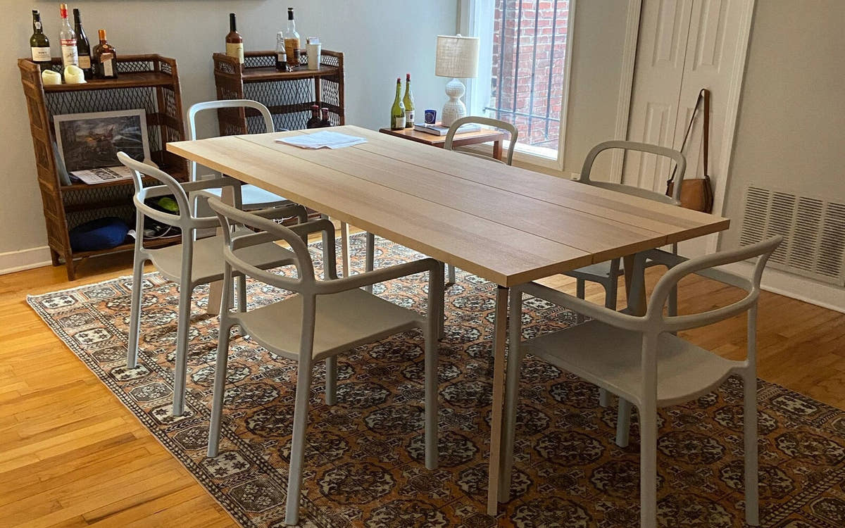 Vintage Turkish Isparta rug under a dining table in a bright room