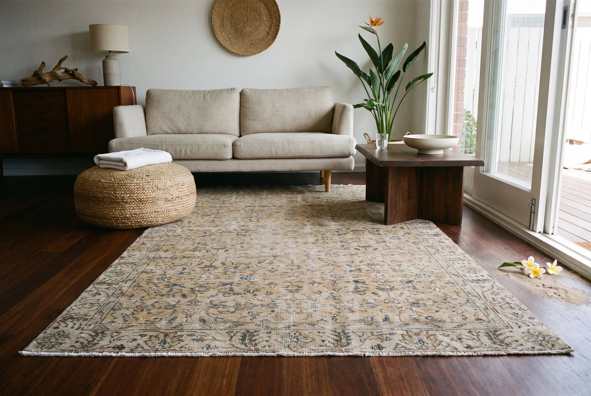 A neutral tan vintage Turkish Isparta rug in a living room in a 1930s brick house in Sydney’s Bondi