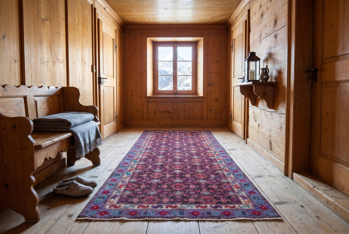 A densely patterned vintage Persian Zanjan runner in the upper hallway of a larch-wood chalet in Zermatt