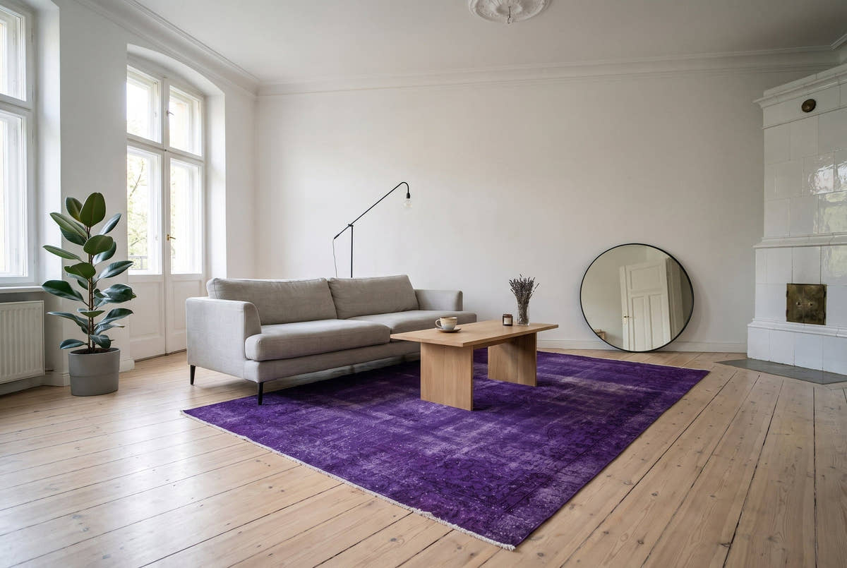 A violet overdyed vintage Turkish Isparta rug in an Altbau apartment living room in Berlin