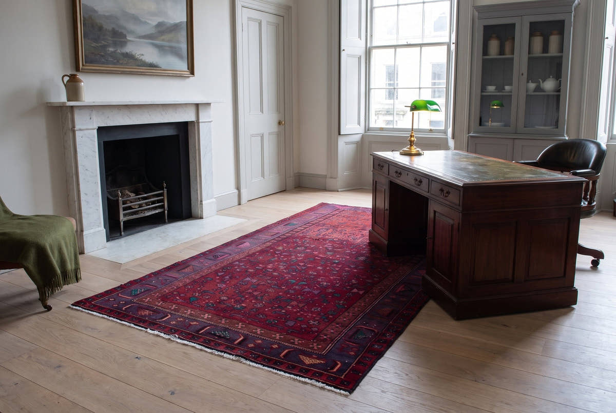 A burgundy vintage Persian Zanjan rug in a study in a Georgian New Town flat in Edinburgh
