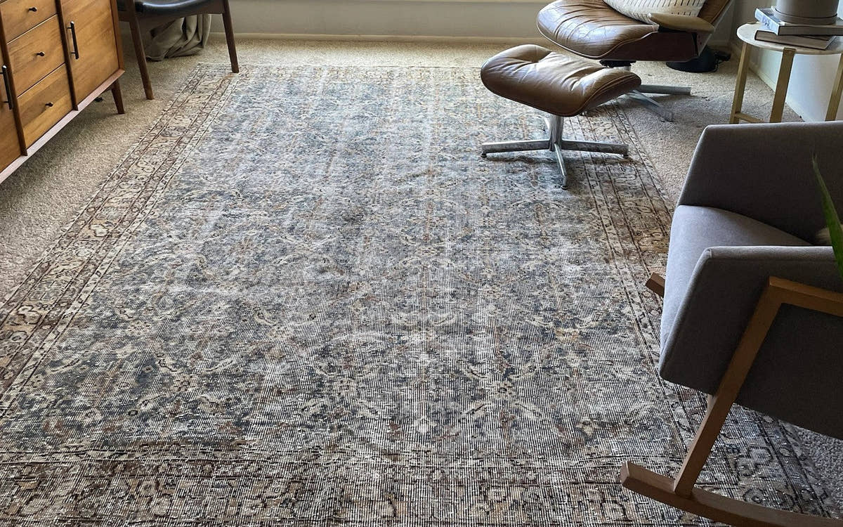 Blue vintage rug in a study with a lounge chair