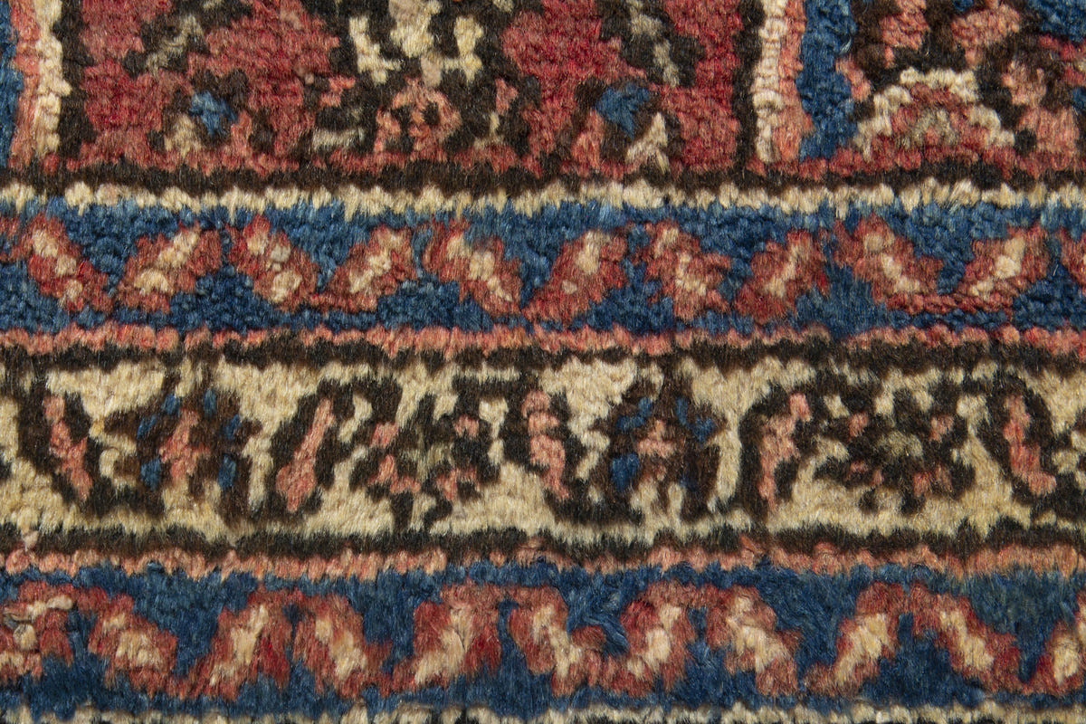 Persian Hamadan accent rug in brick and navy, view 9 of 10