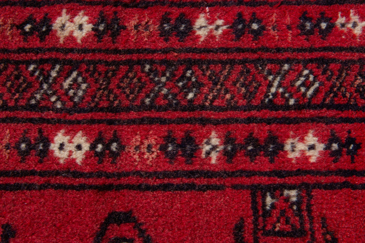 Persian Torkaman accent rug in deep red and black, view 8 of 9