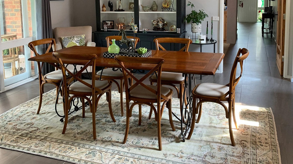 A dining table centred on a vintage rug with room for chairs