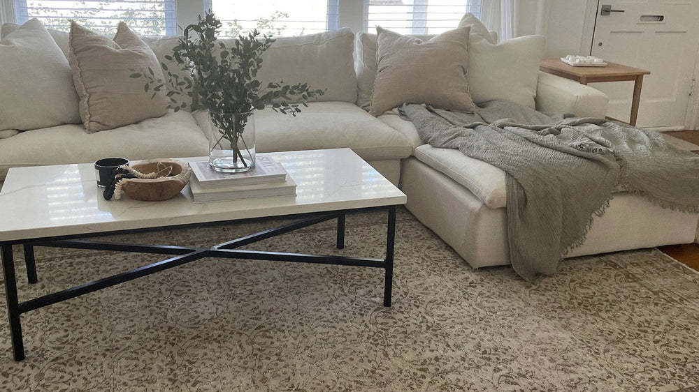 A vintage rug anchoring seating in an open-plan living space
