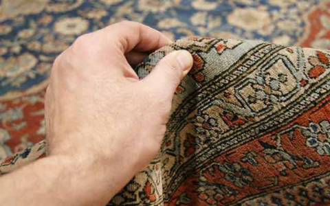 Hand-knotted rug construction, knots tied one at a time onto the warp