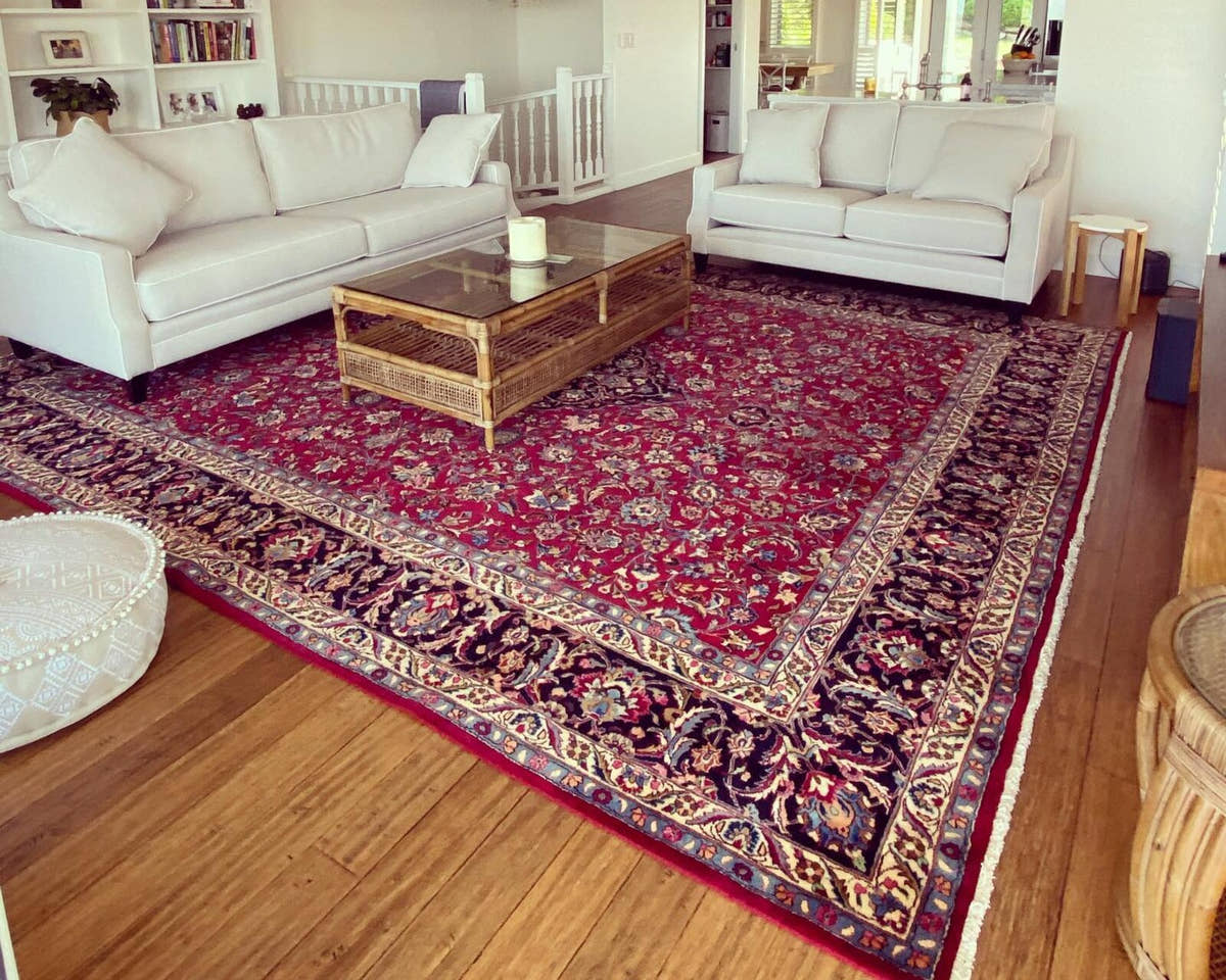 Vintage Persian Mashhad rug in a living room