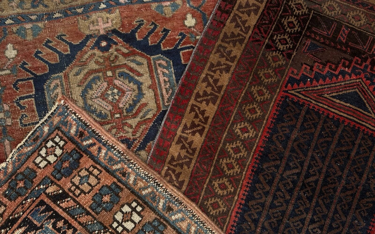 Stack of colorful vintage Persian and Turkish rugs