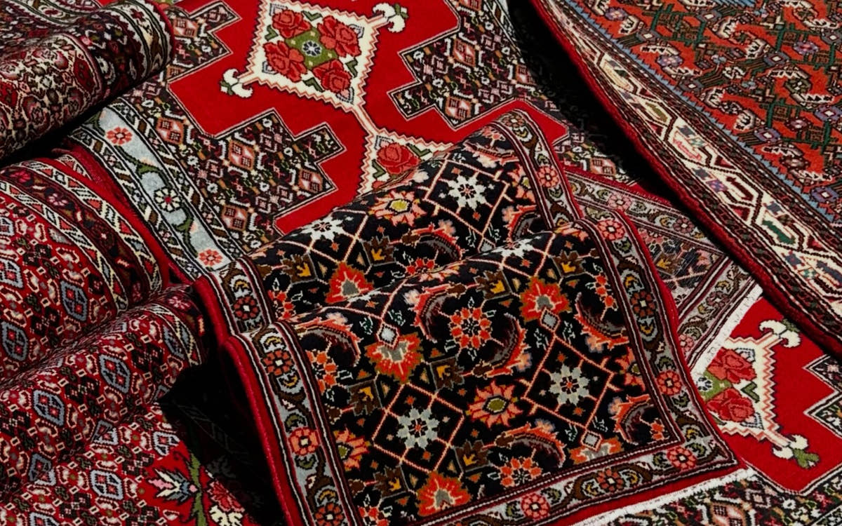 Detail of a red vintage Persian rug with a geometric medallion