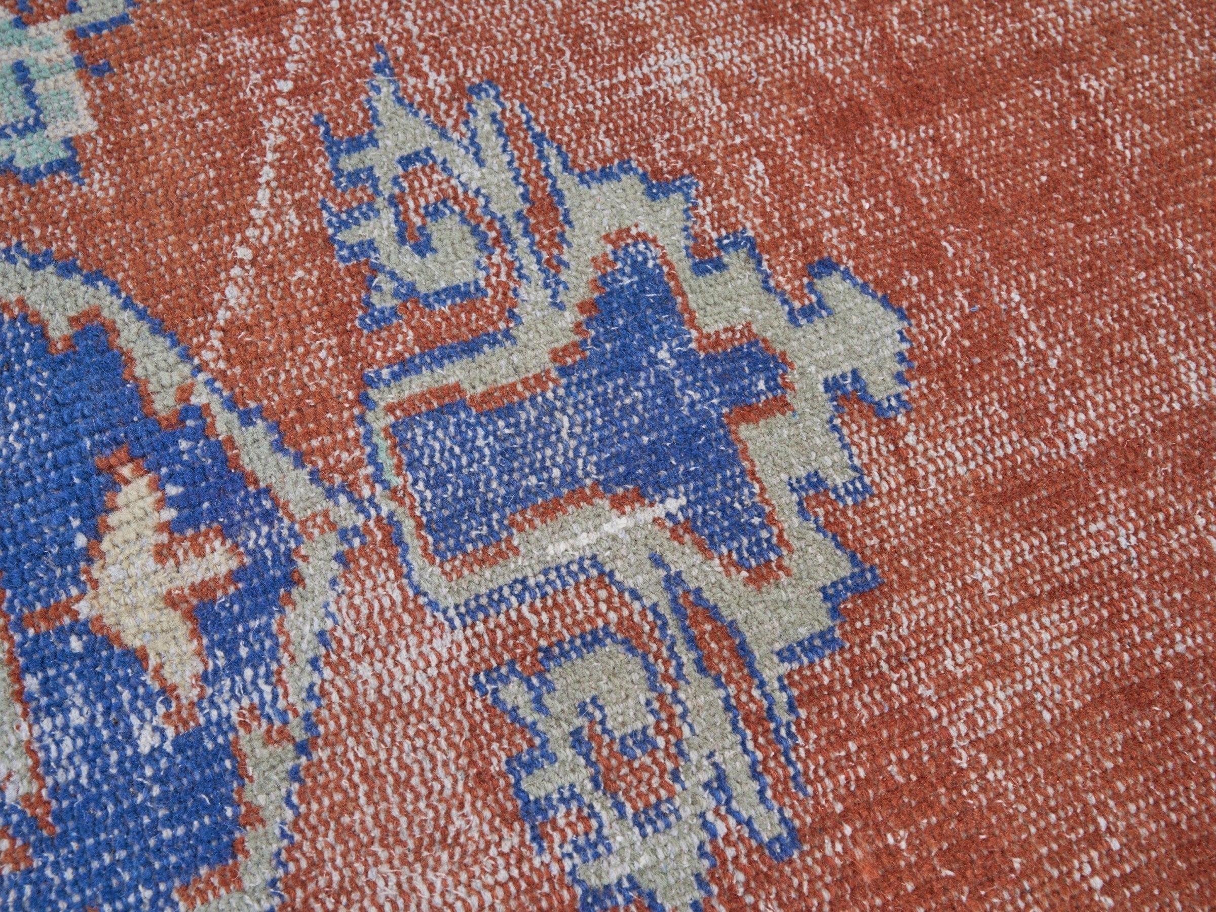 Turkish Manisa area rug in rust and navy, view 7 of 10