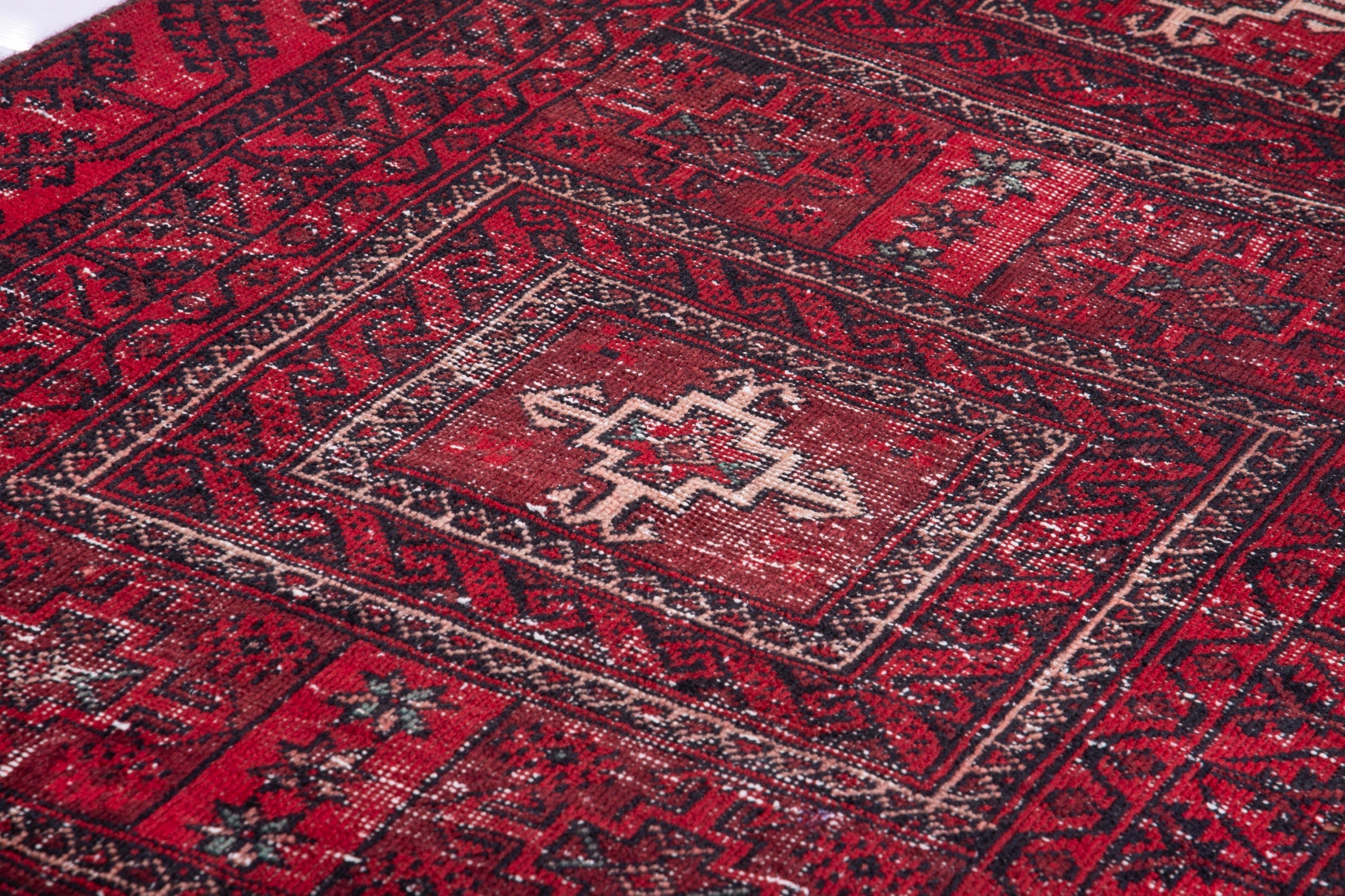 Persian Baluch runner rug in deep red and faded red, view 10 of 17