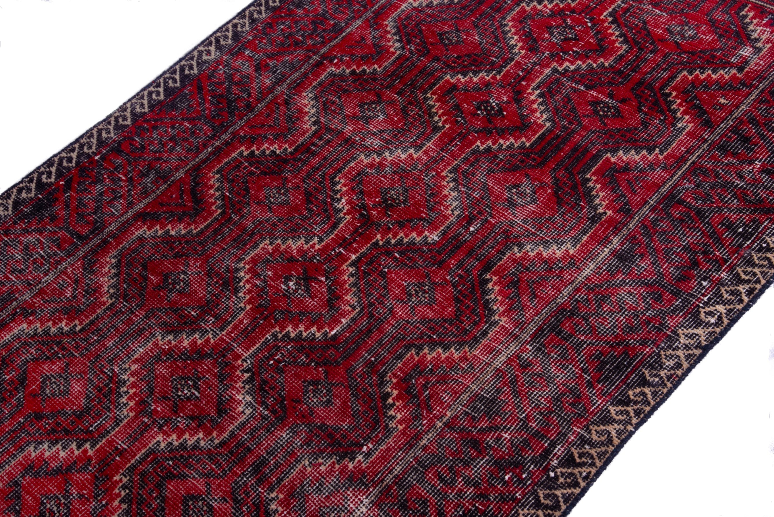 Persian Baluch runner rug in deep red and faded red, view 6 of 17