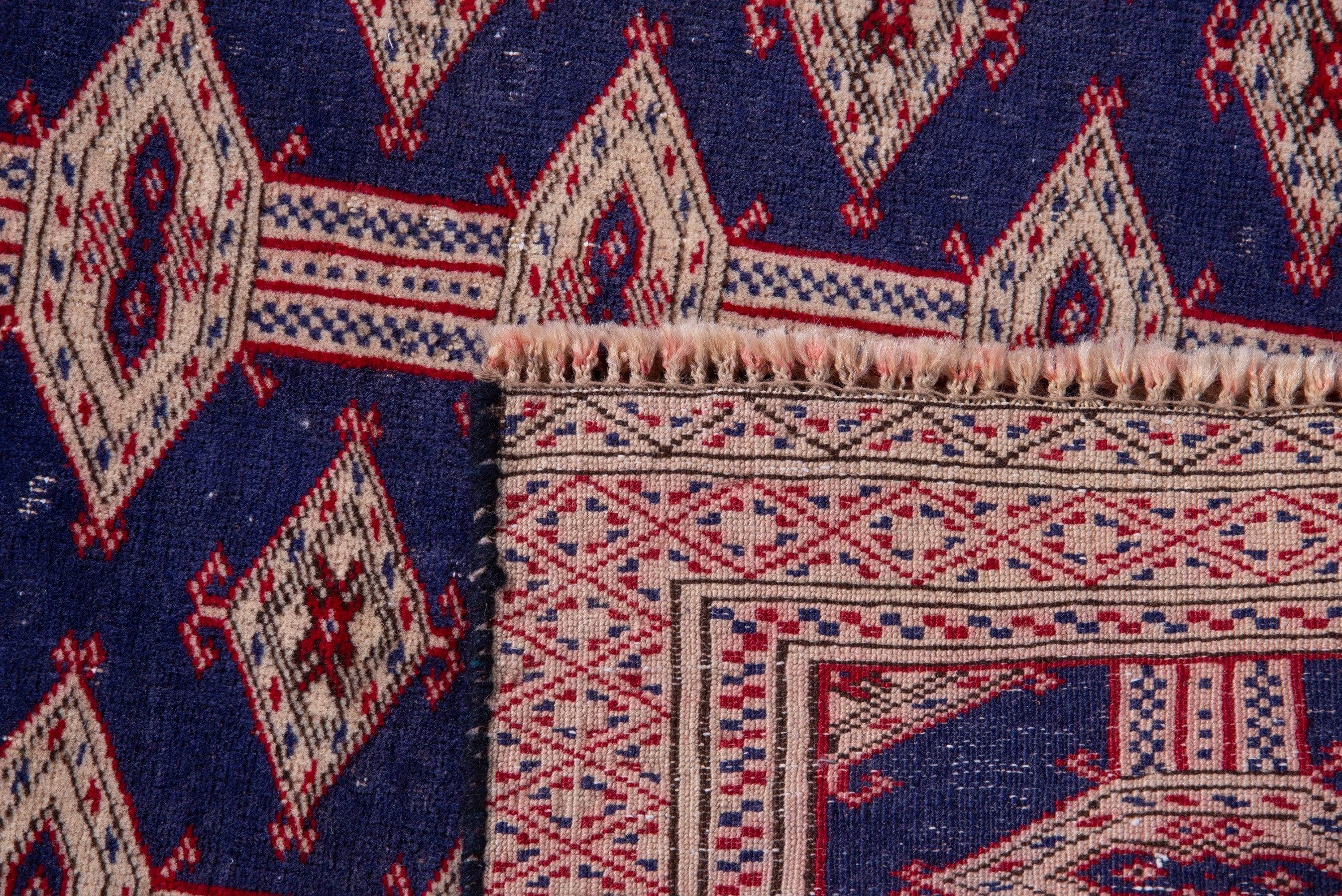 Persian Torkaman accent rug in navy and rose, view 15 of 15