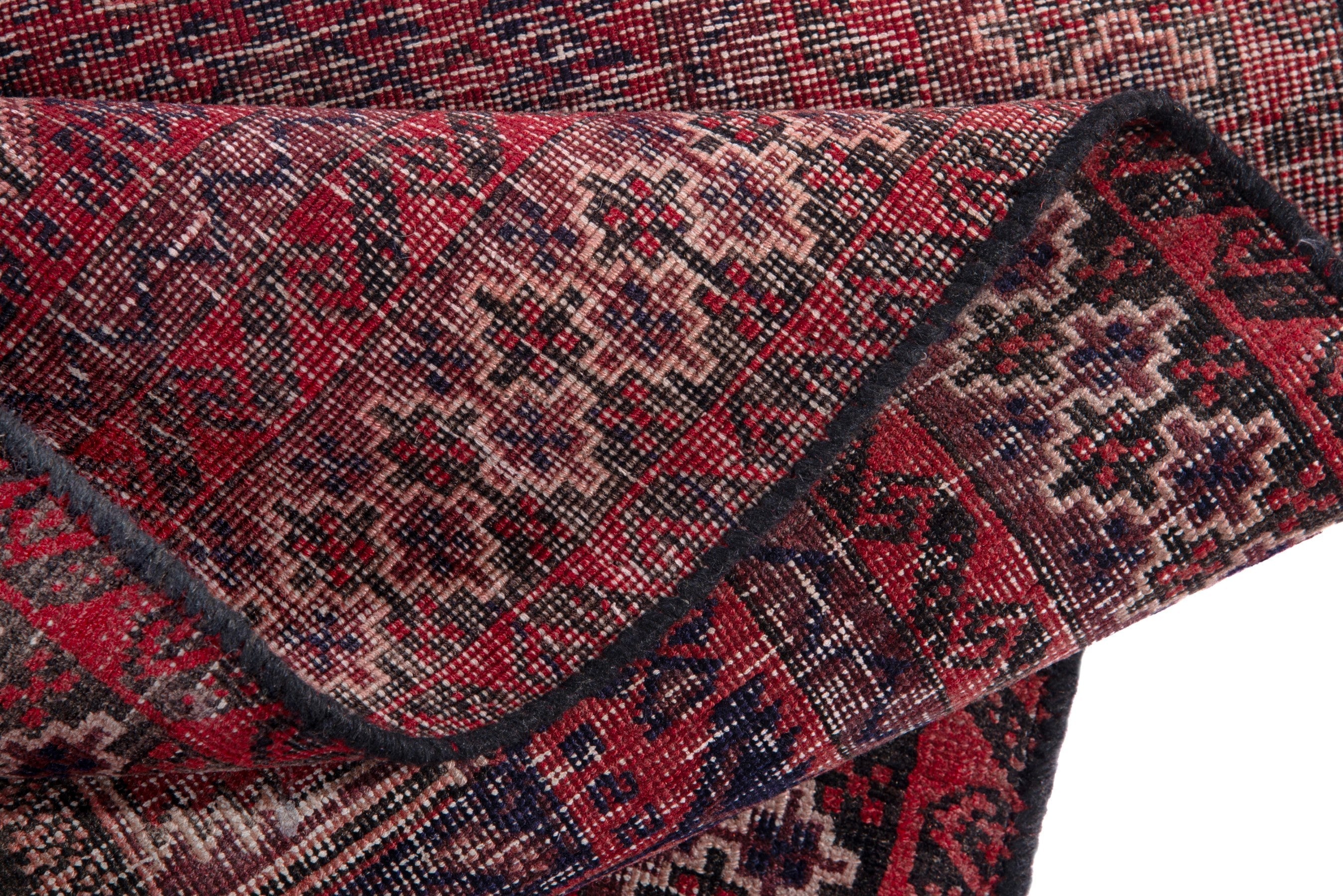 Persian Baluch accent rug in deep red and faded red, view 14 of 15