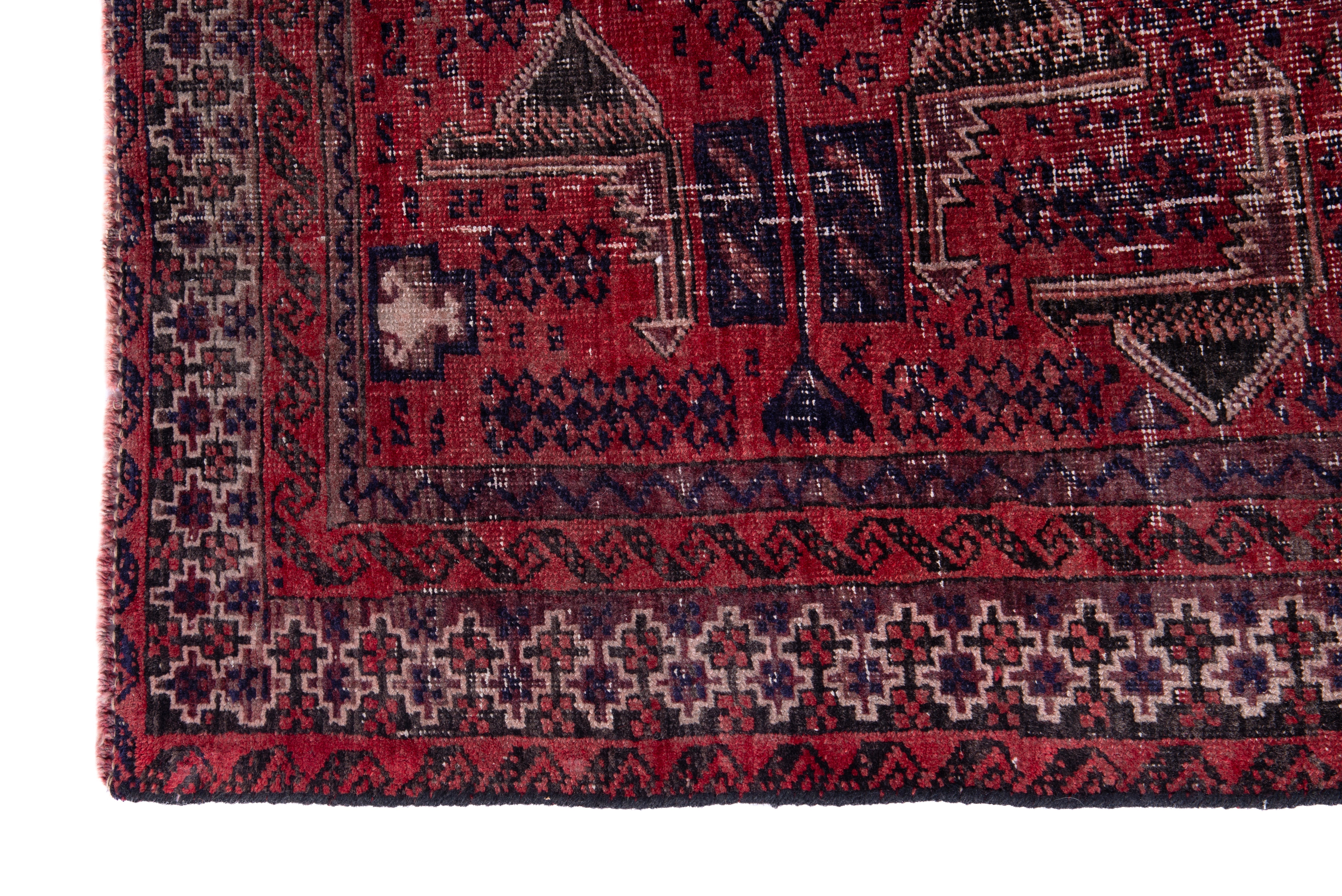 Persian Baluch accent rug in deep red and faded red, view 5 of 15