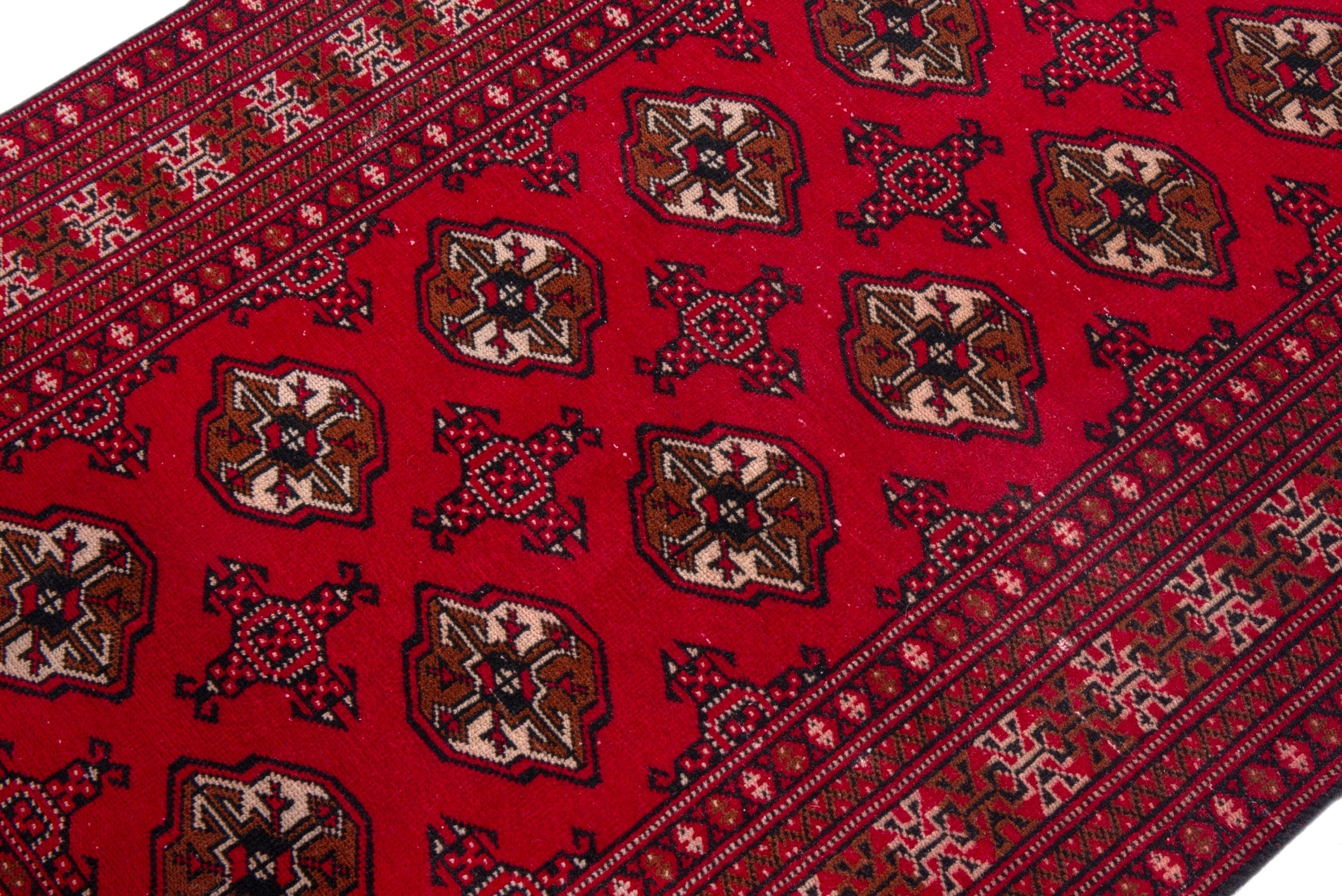 Persian Torkaman accent rug in deep red and tan, view 6 of 17