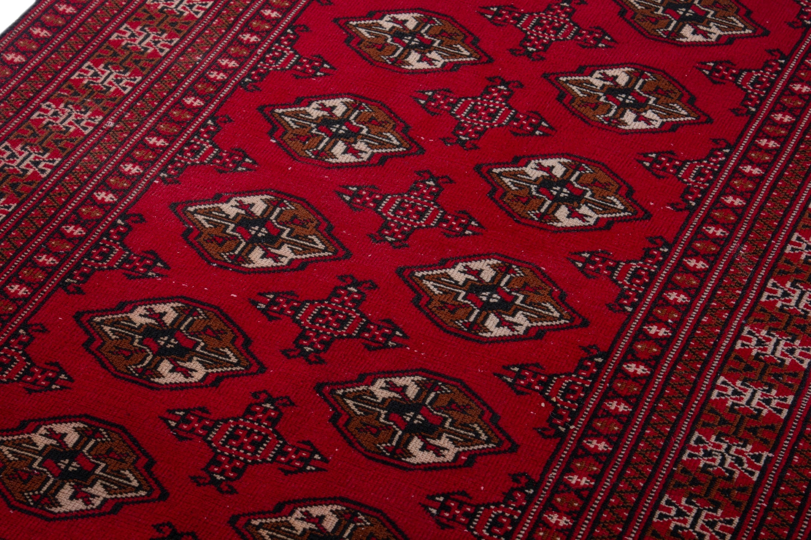 Persian Torkaman accent rug in deep red and tan, view 9 of 17