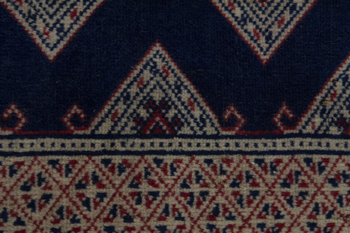 Persian Torkaman accent rug in navy and greige, view 8 of 9