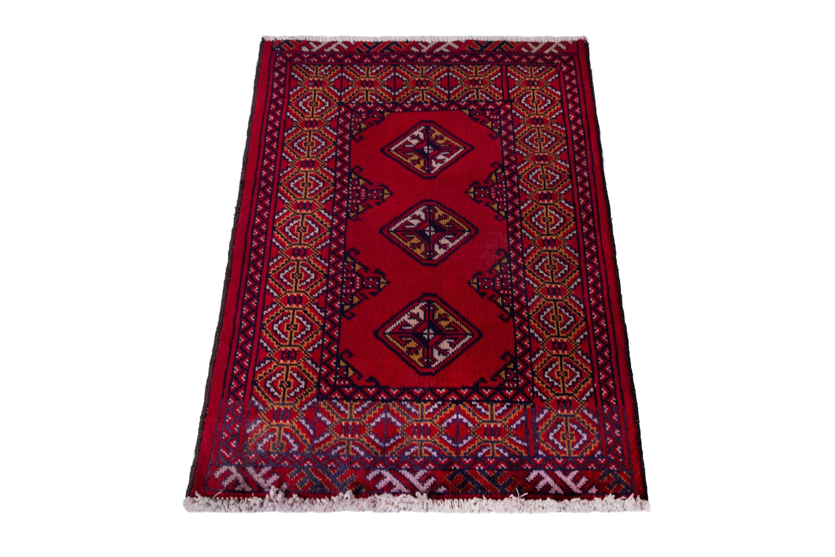 Persian Torkaman accent rug in deep red and navy, view 2 of 8