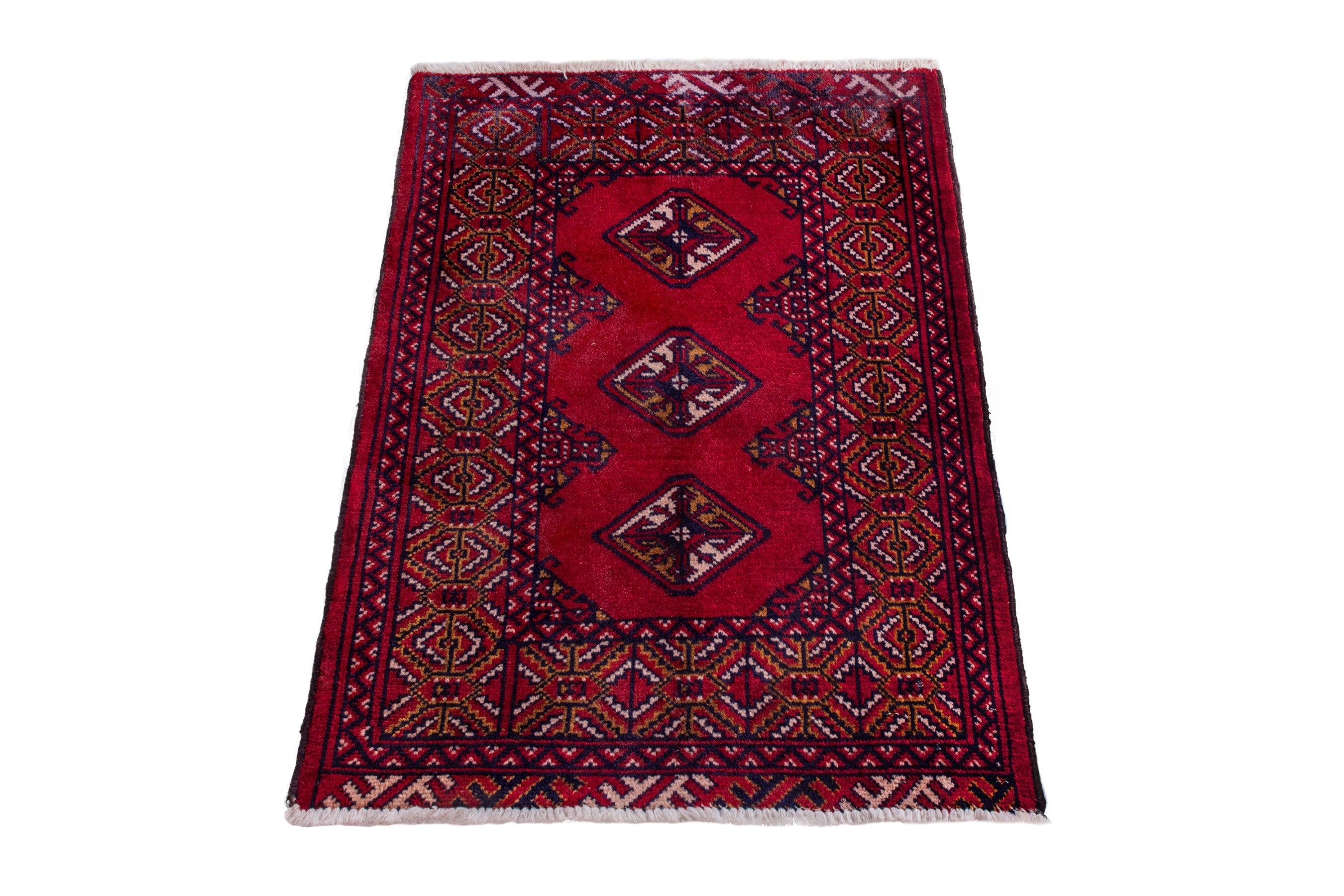 Persian Torkaman accent rug in deep red and navy, view 3 of 8