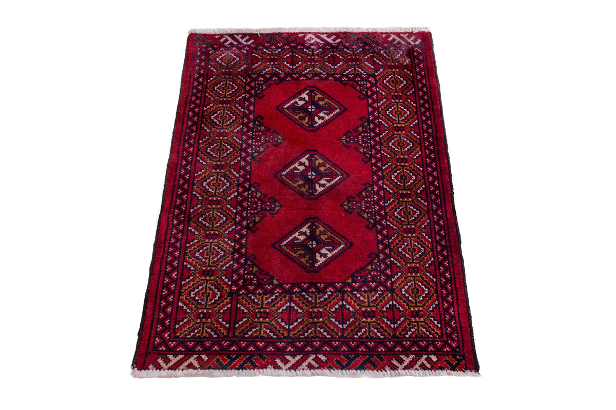 Persian Torkaman accent rug in deep red and navy, view 4 of 9