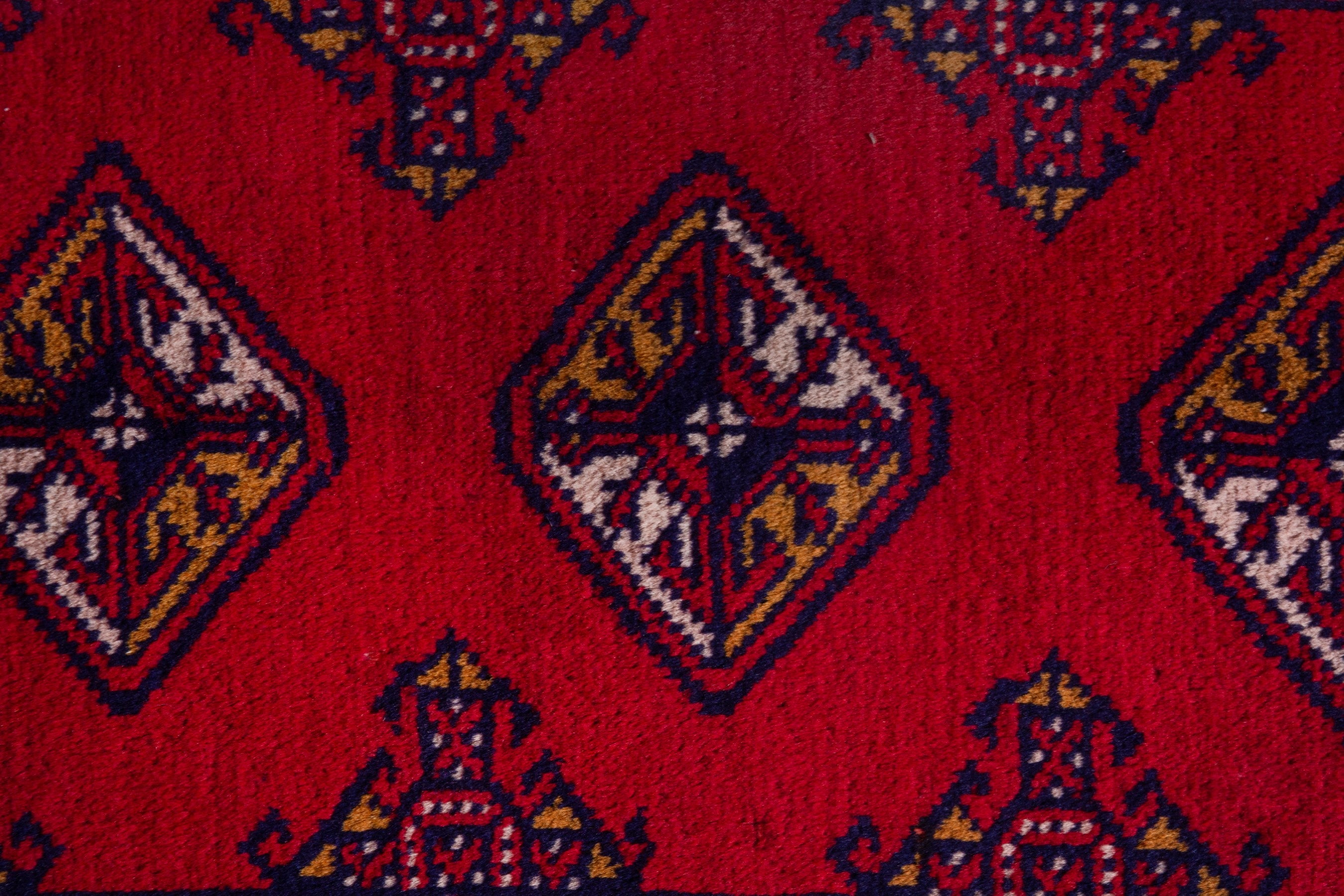 Persian Torkaman accent rug in deep red and navy, view 6 of 8