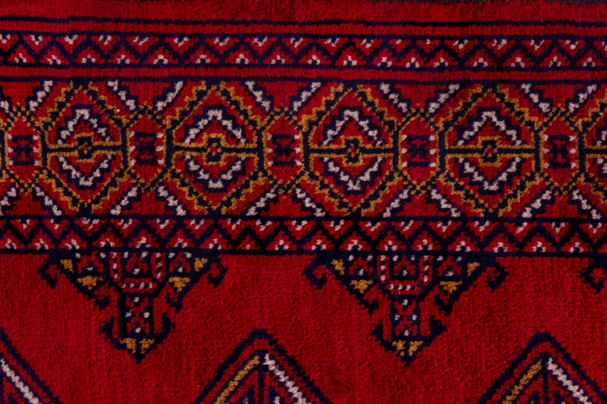 Persian Torkaman accent rug in deep red and navy, view 8 of 9