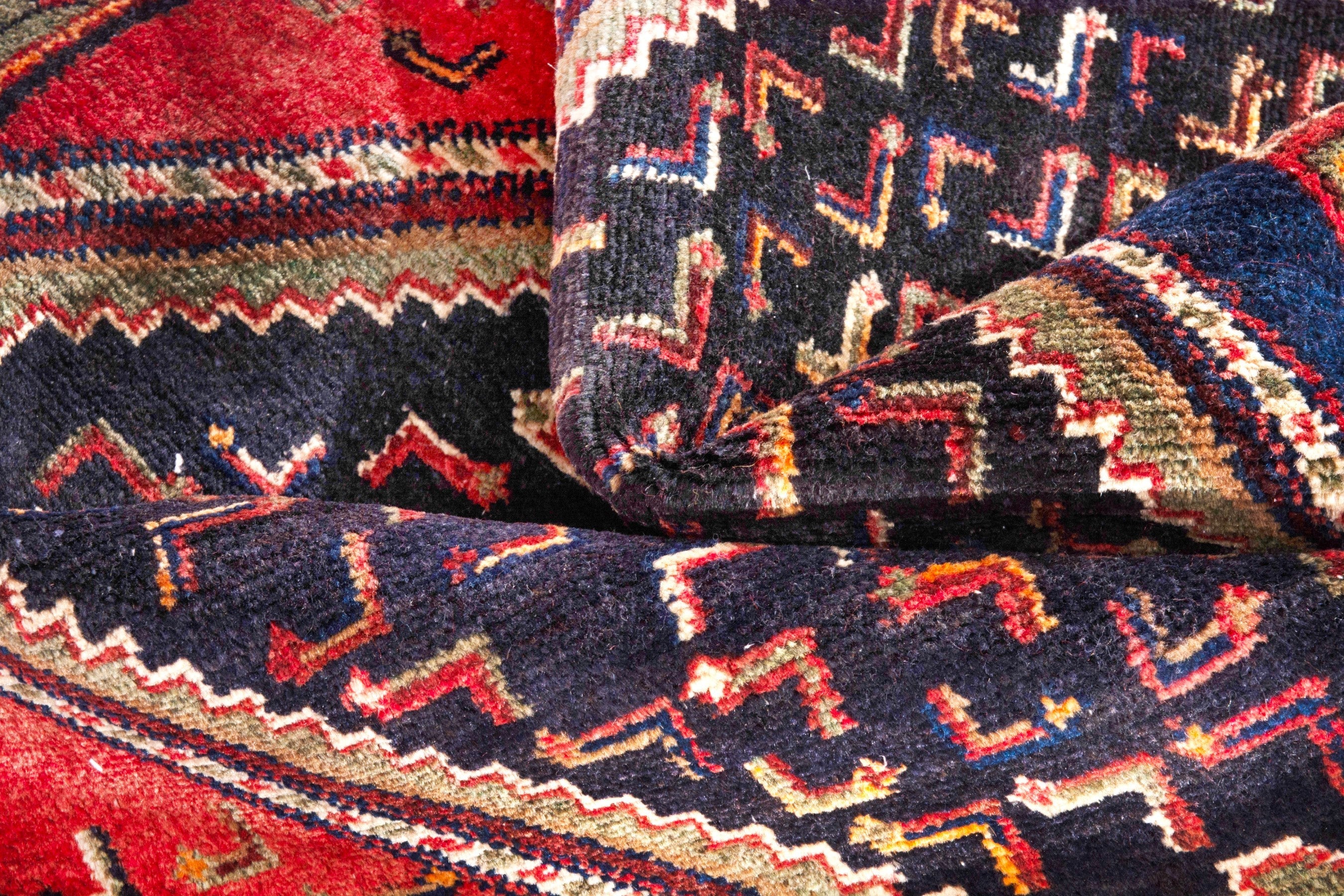 Persian Songhor area rug in navy and rust, view 19 of 20
