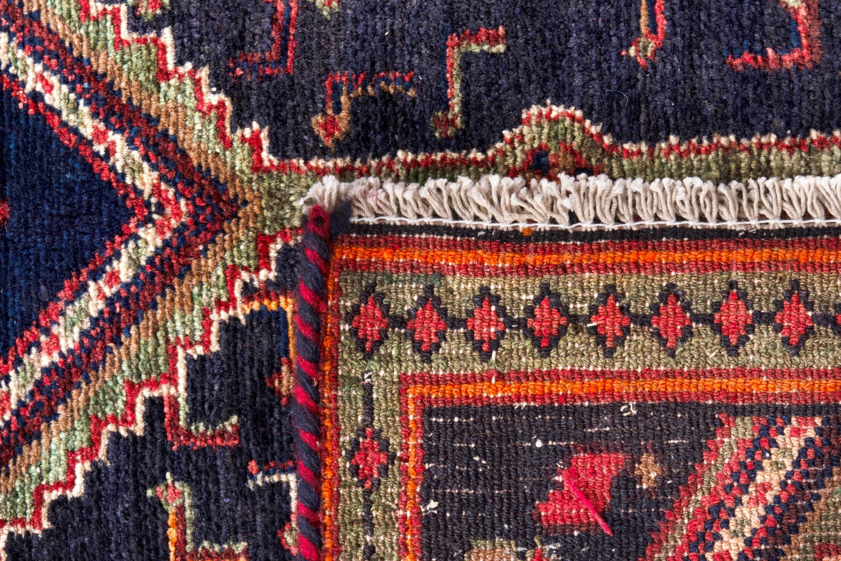 Persian Songhor area rug in navy and rust, view 20 of 20