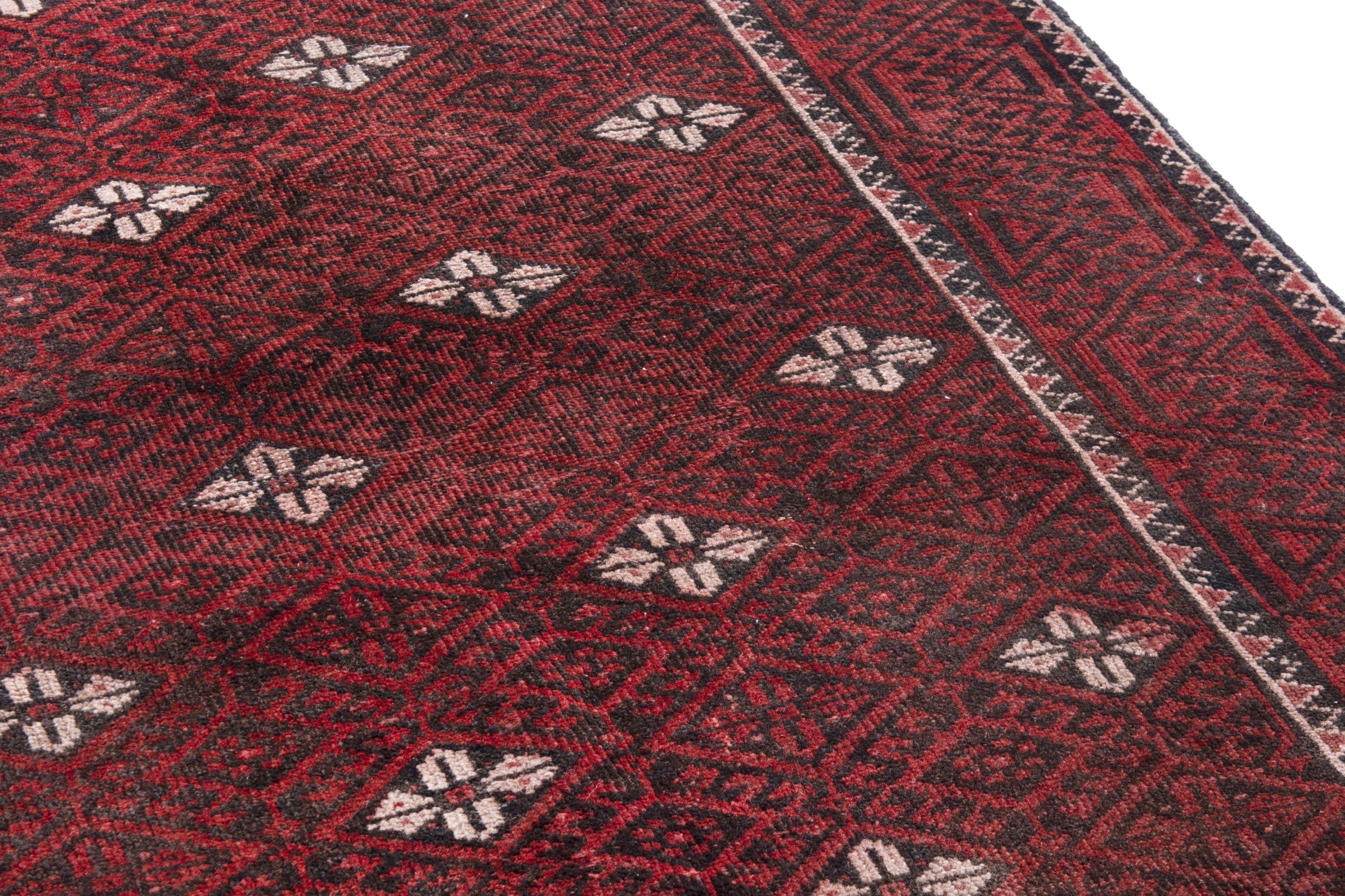 Persian Baluch accent rug in deep red and cream, view 10 of 18