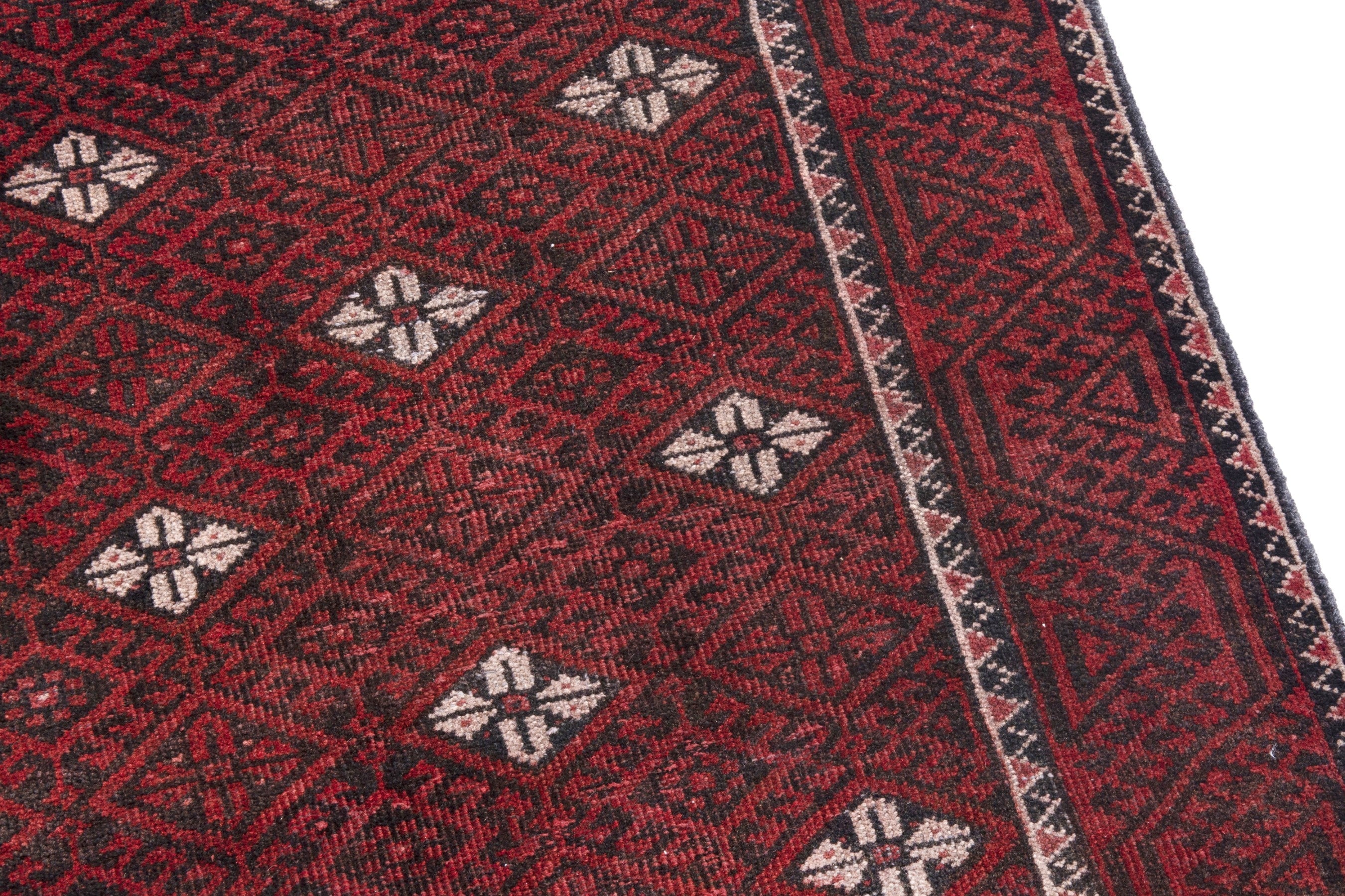 Persian Baluch accent rug in deep red and cream, view 7 of 18