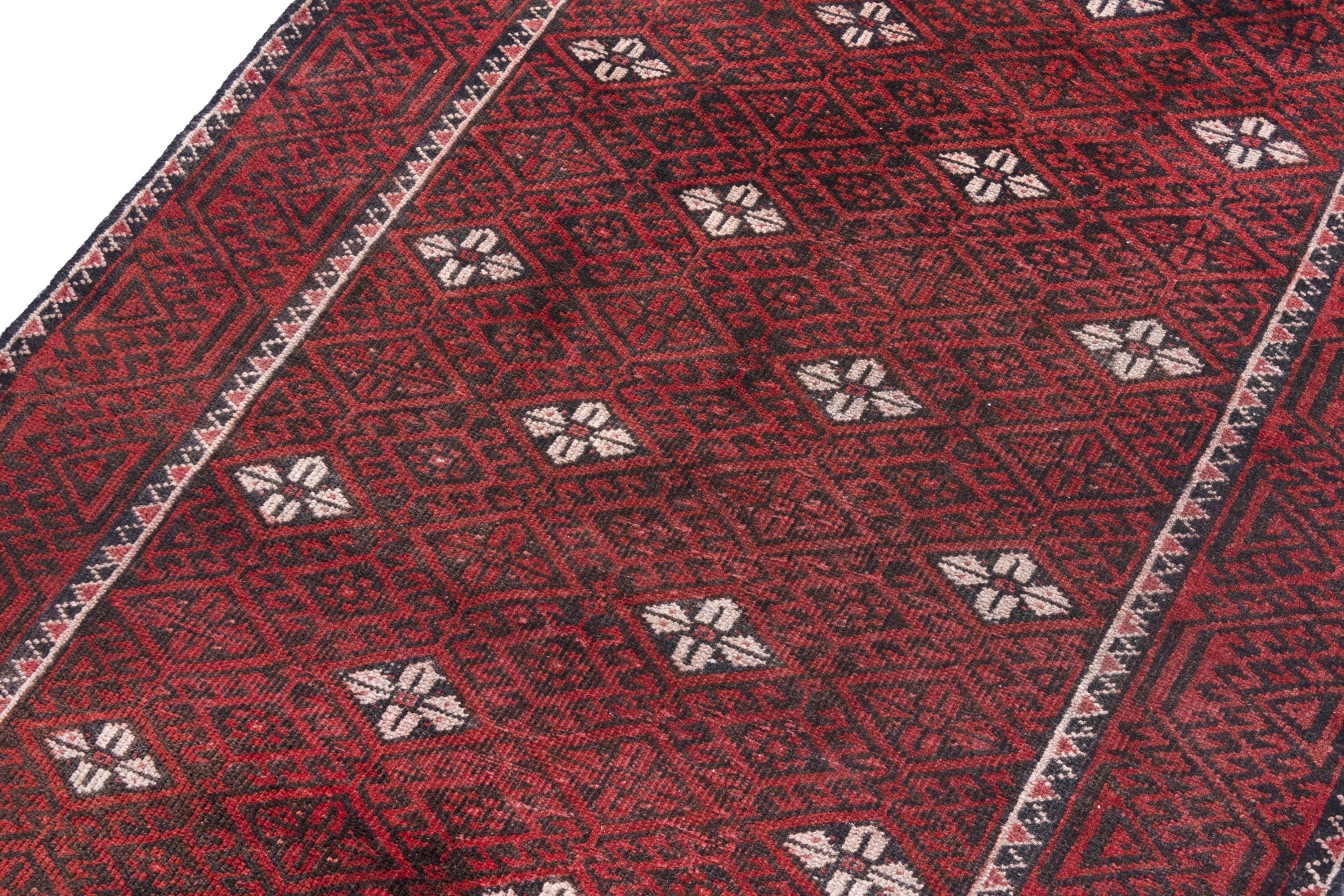 Persian Baluch accent rug in deep red and cream, view 9 of 18