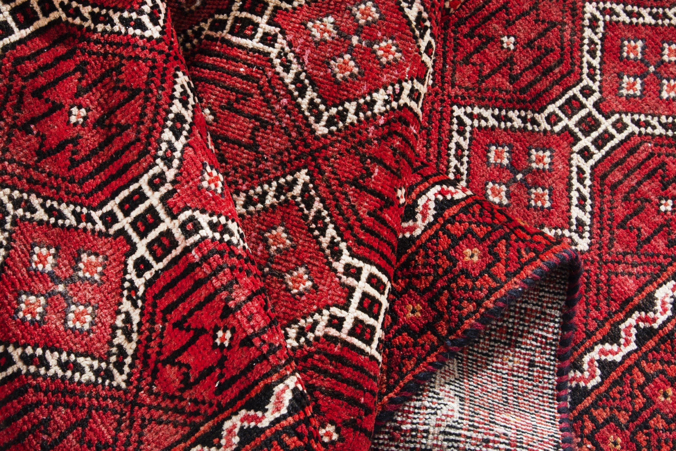 Persian Baluch runner rug in deep red and cream, view 14 of 17