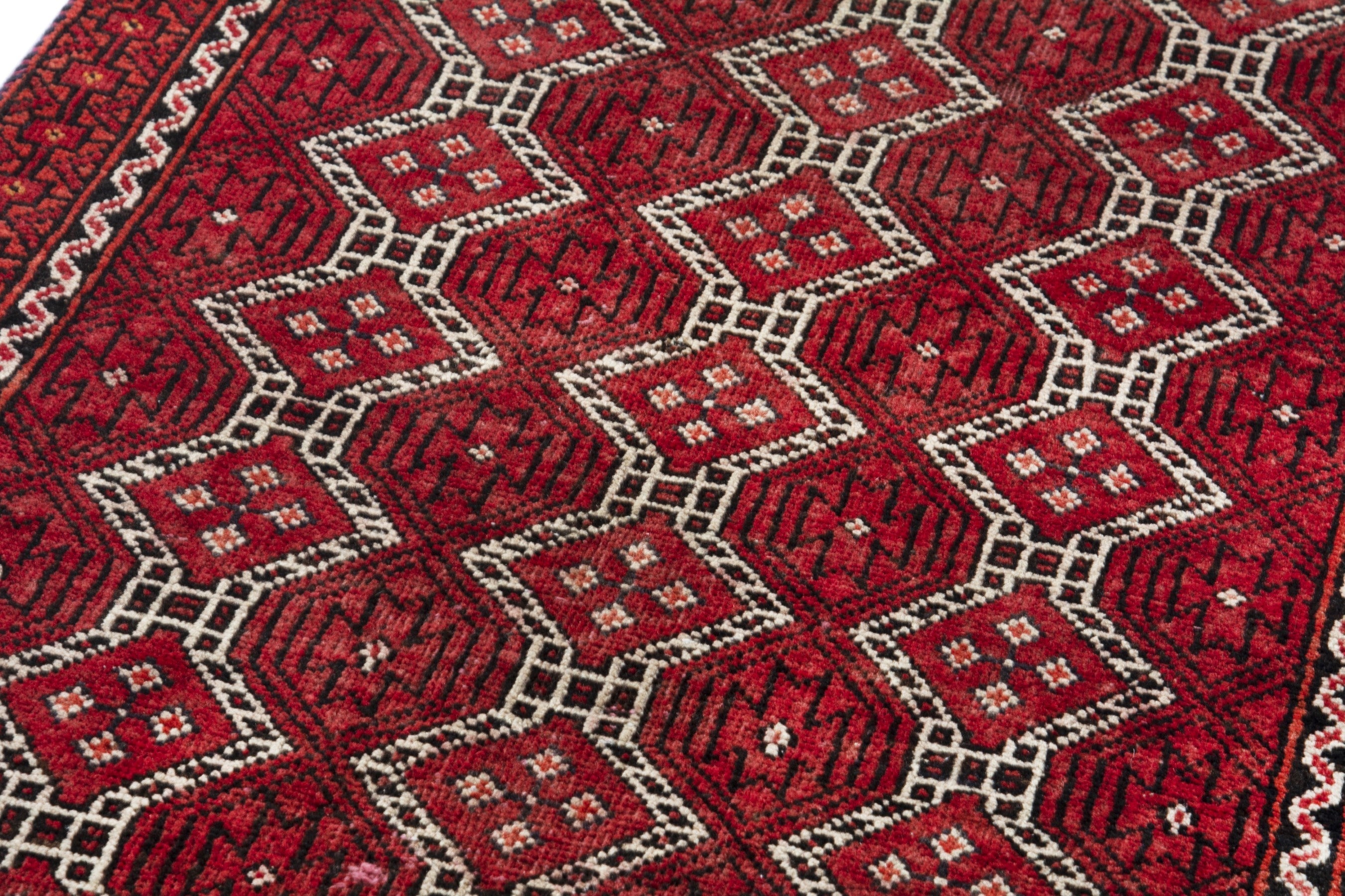 Persian Baluch runner rug in deep red and cream, view 9 of 17