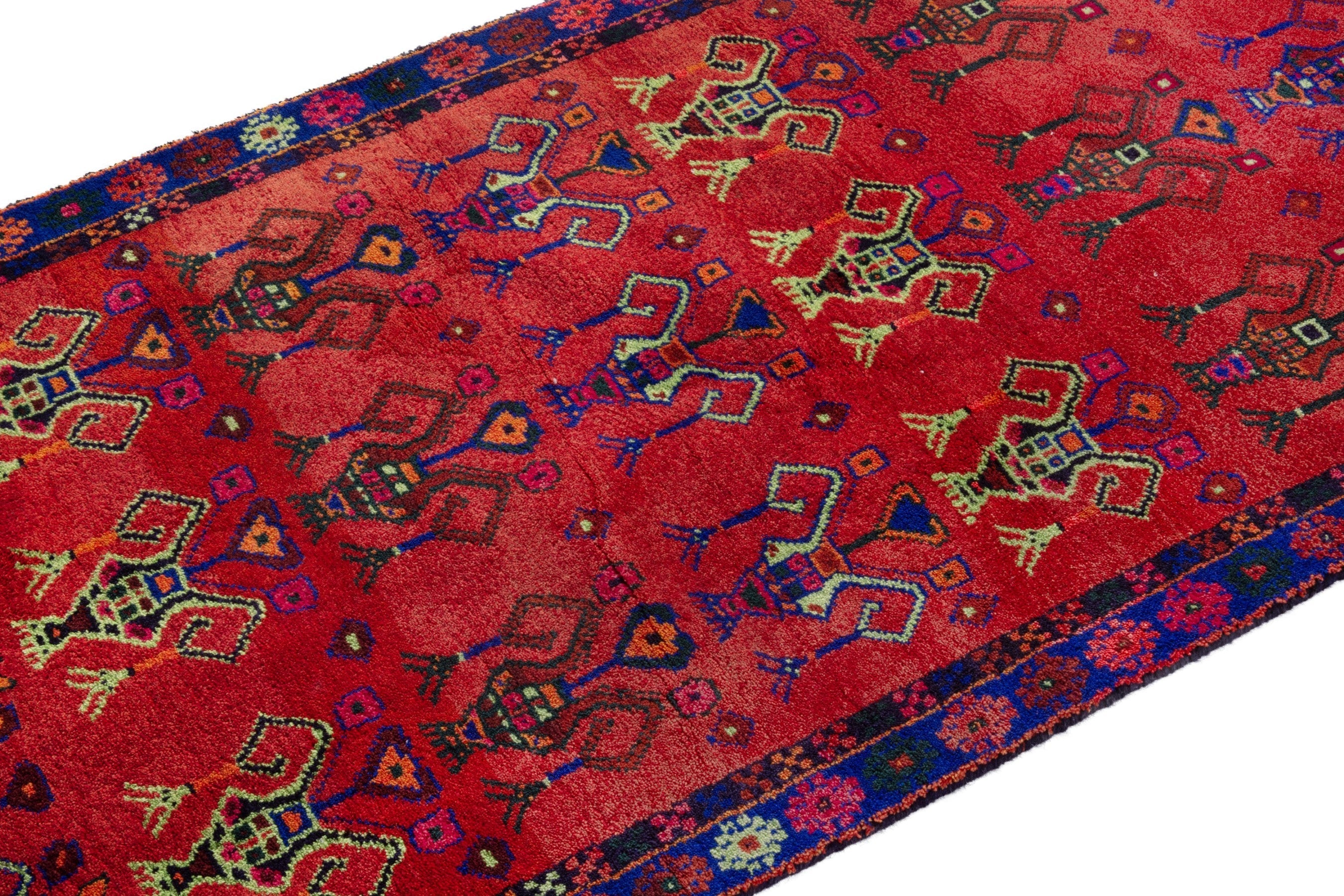 Persian Lori accent rug in deep red and navy, view 6 of 18