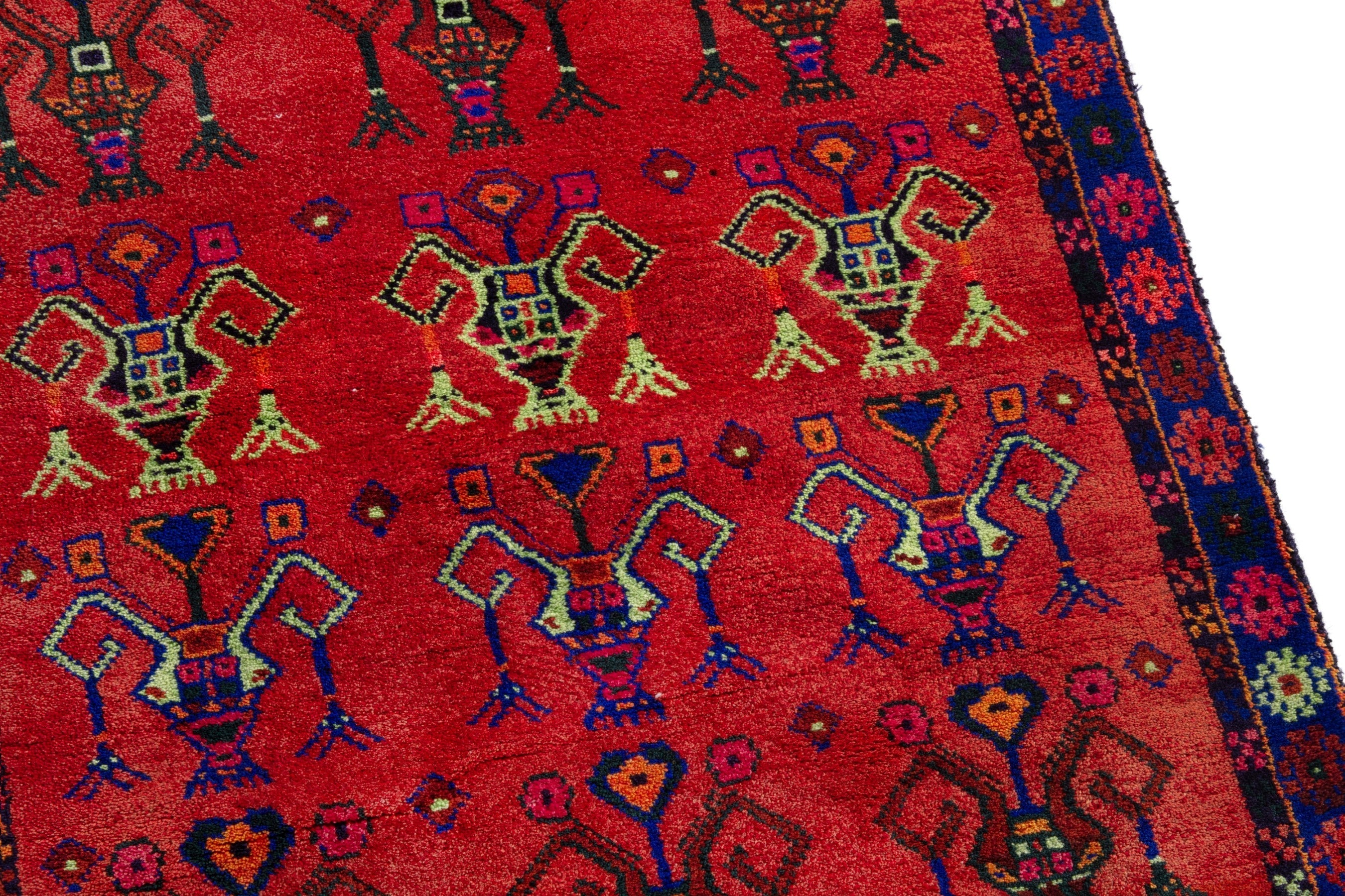 Persian Lori accent rug in deep red and navy, view 7 of 18