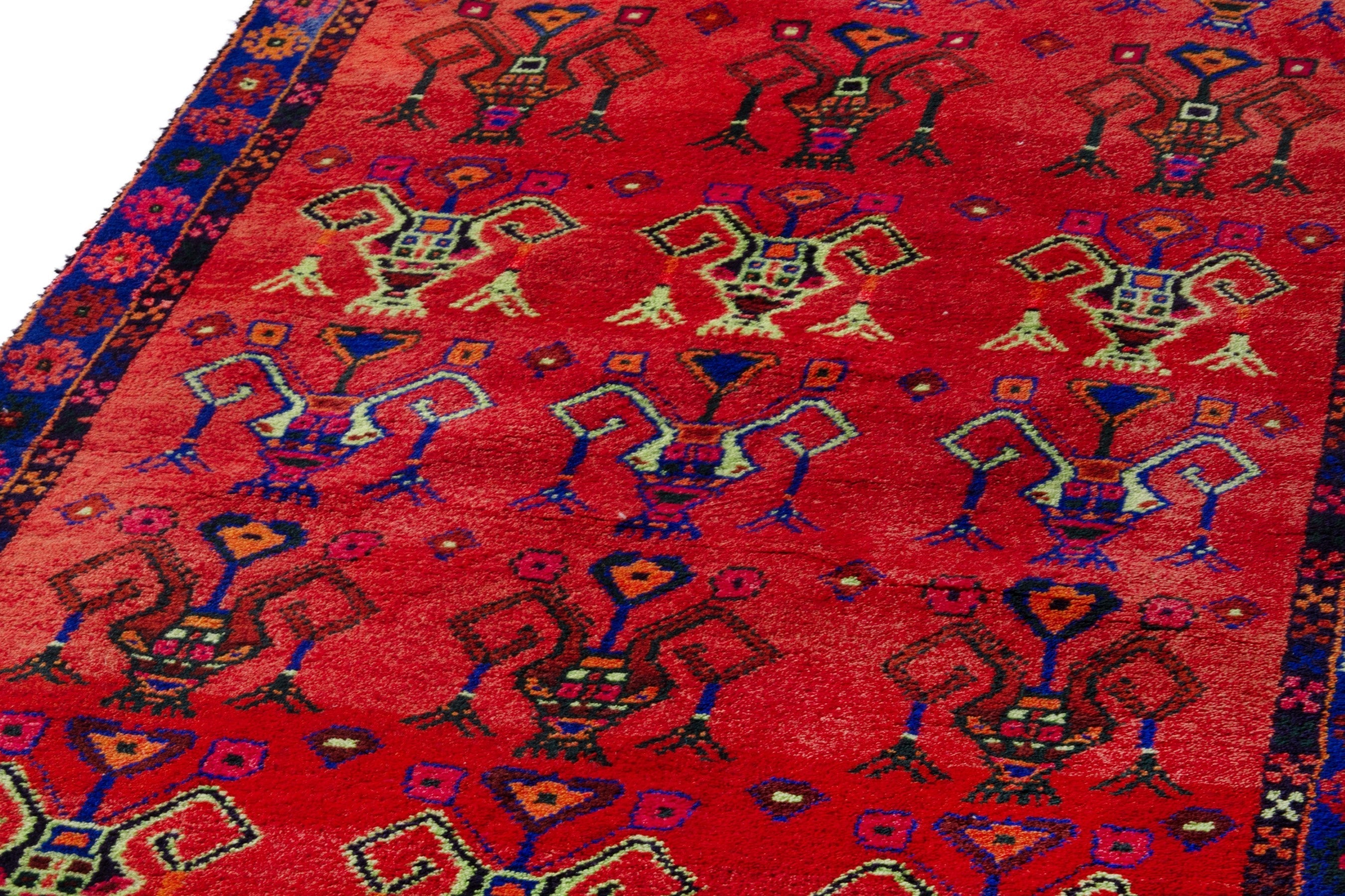 Persian Lori accent rug in deep red and navy, view 9 of 18