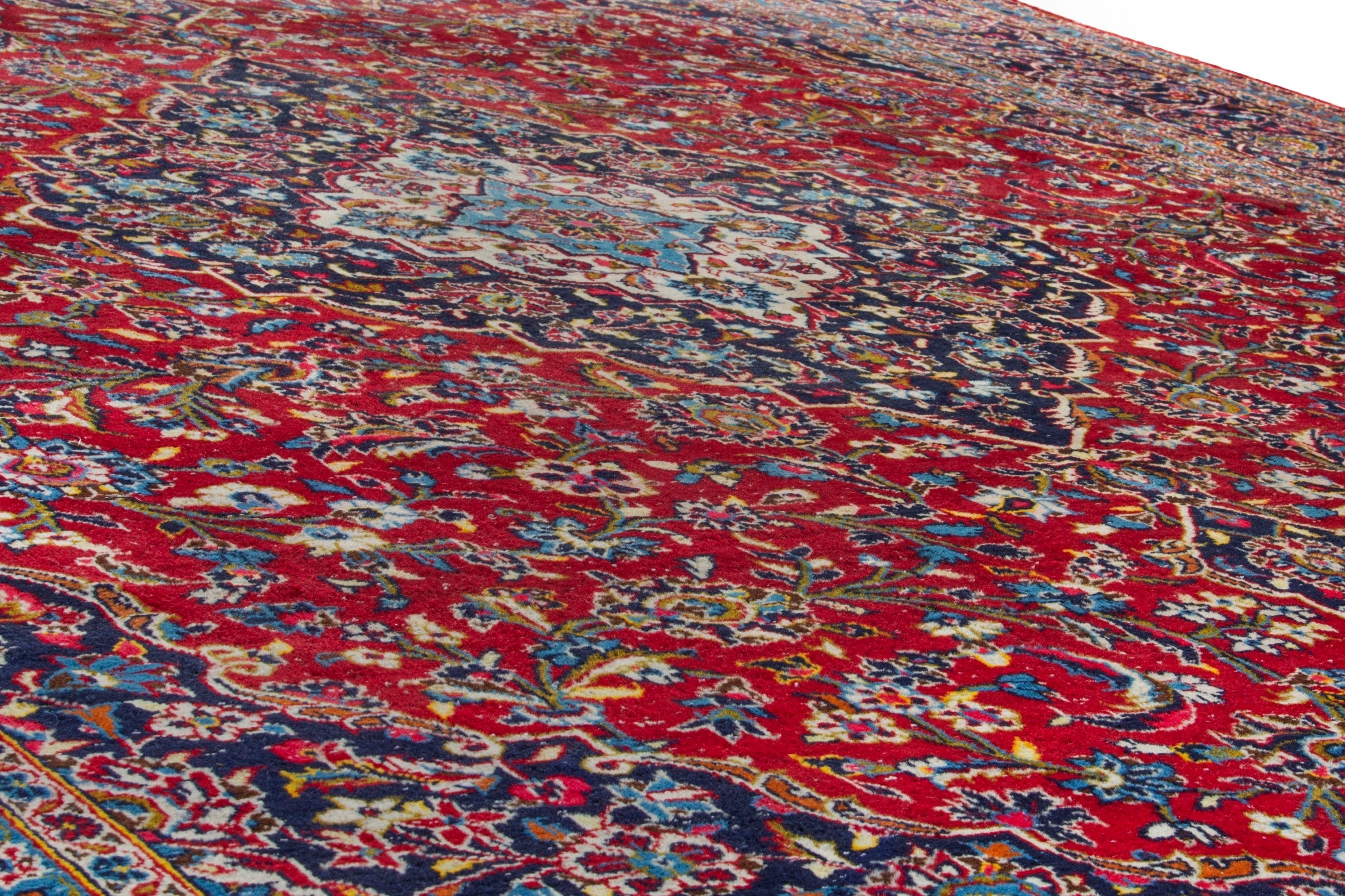 Persian Kashan oversized rug in deep red and navy, view 9 of 20