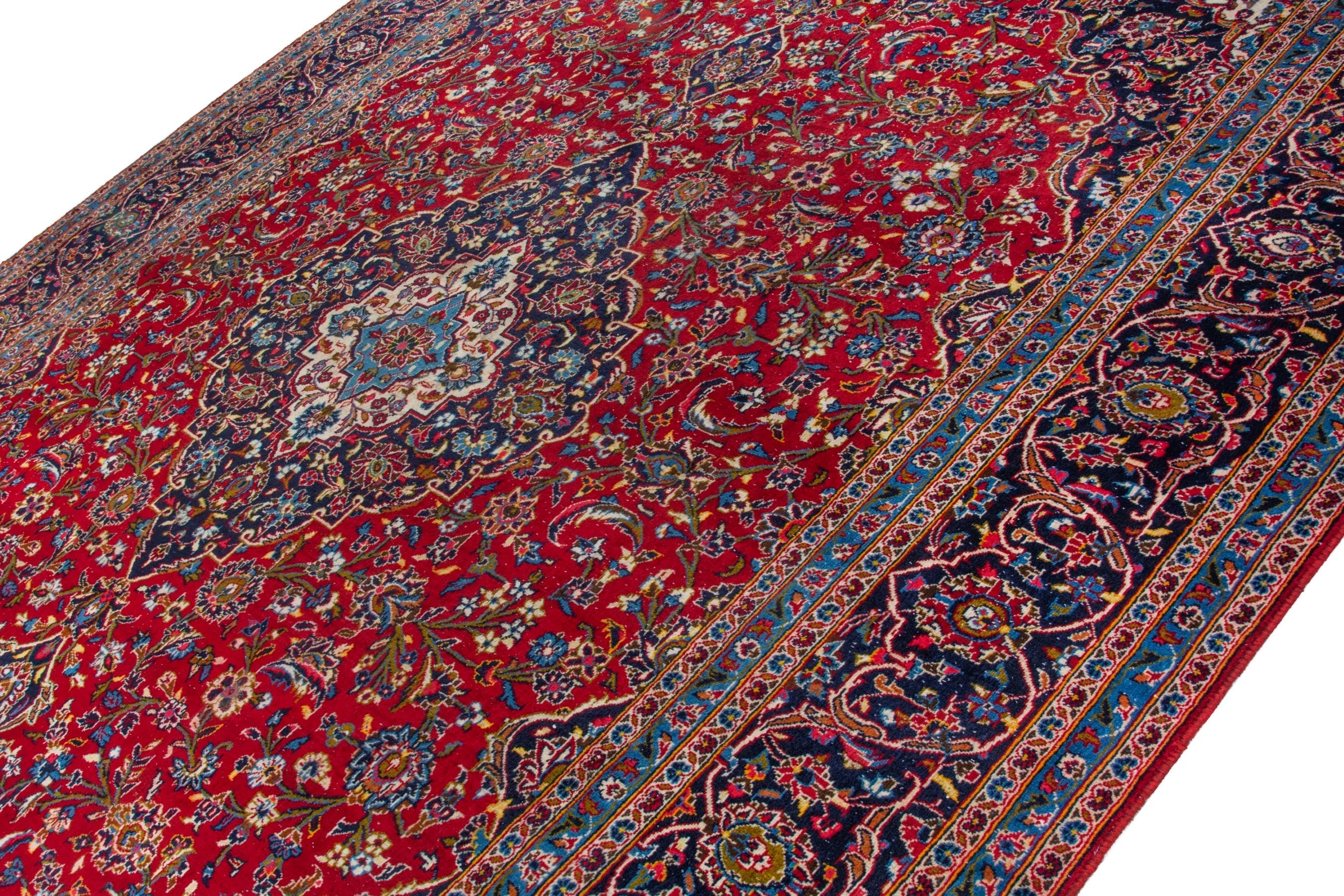 Persian Kashan oversized rug in deep red and navy, view 5 of 20