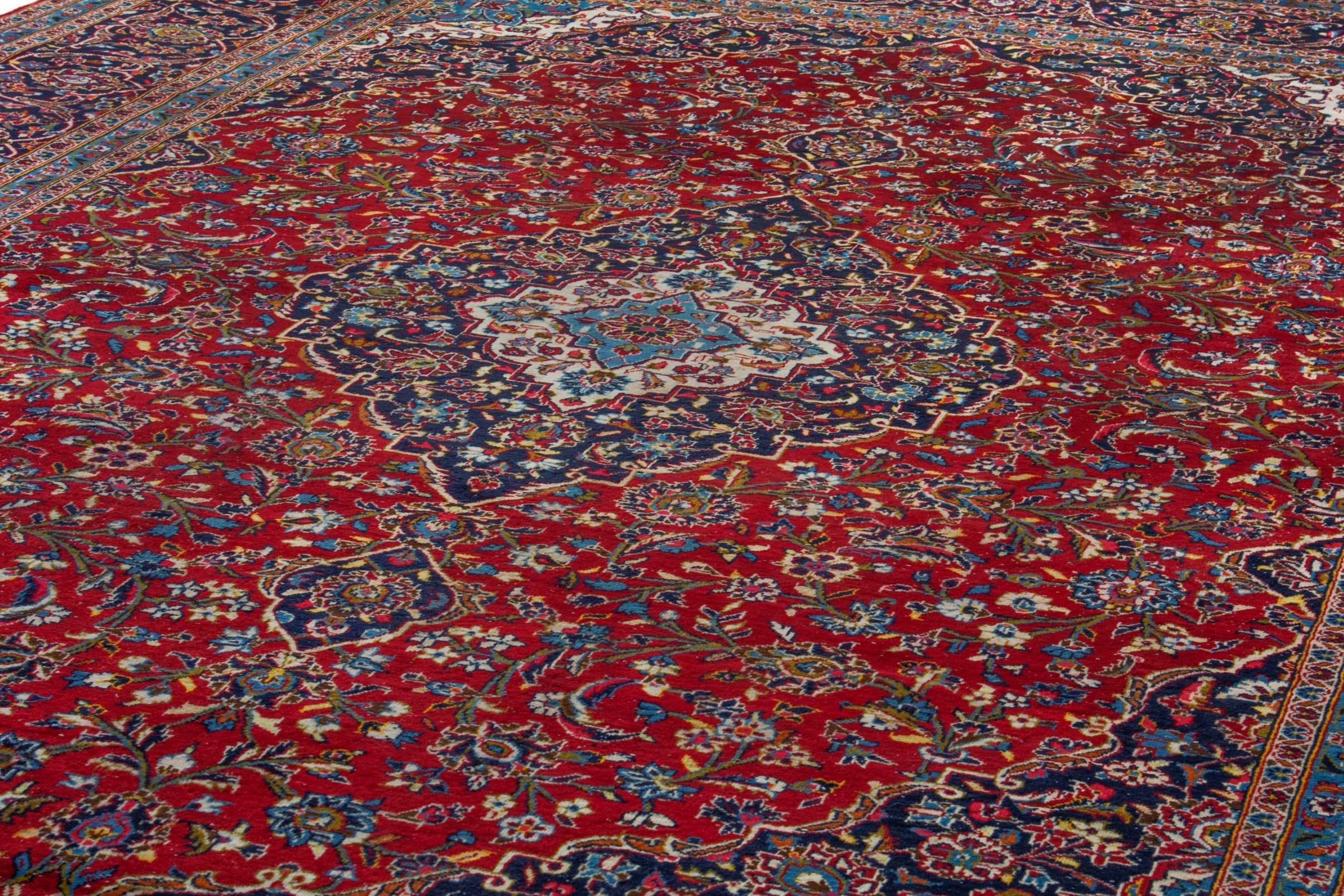 Persian Kashan oversized rug in deep red and navy, view 8 of 20