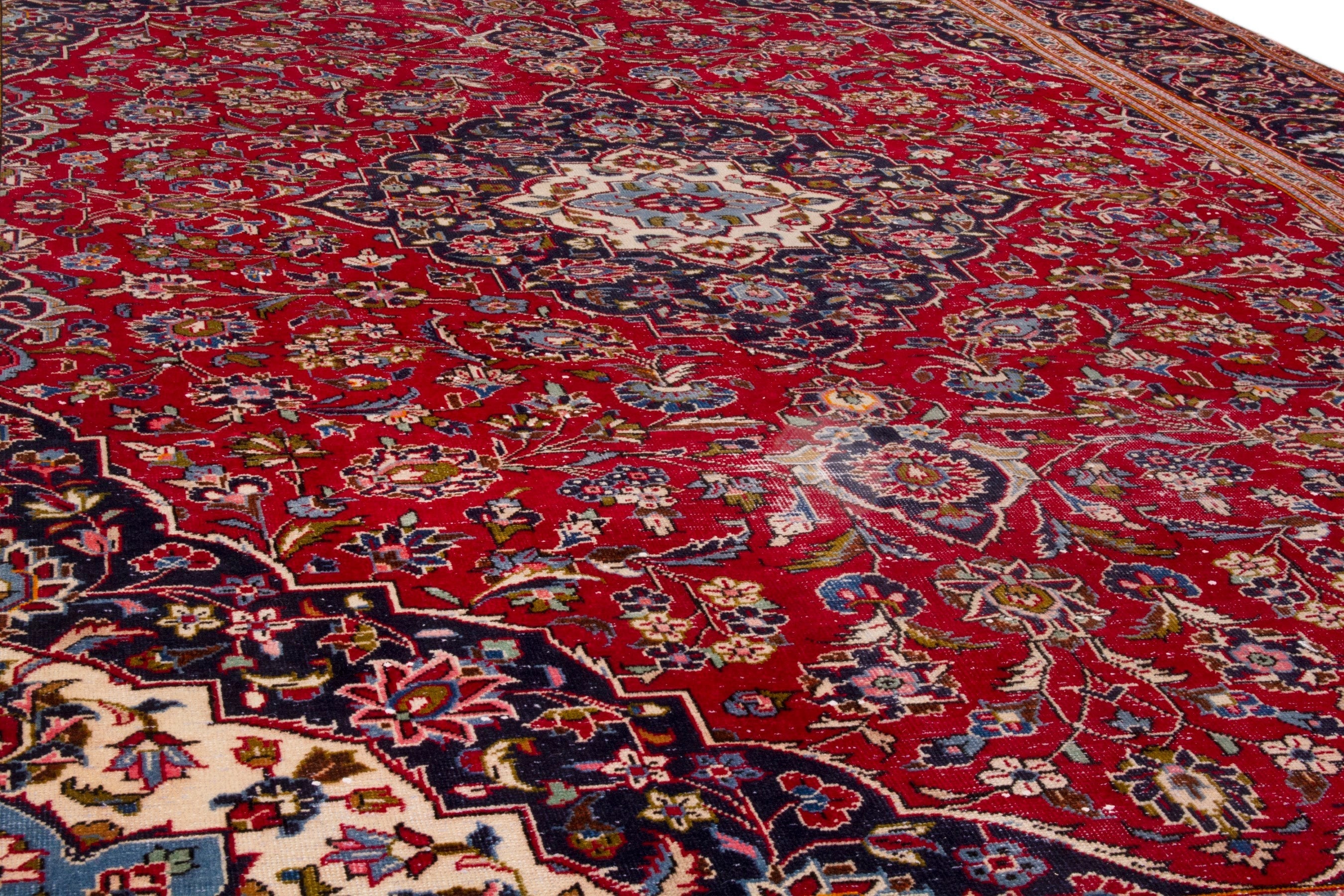 Persian Kashan oversized rug in deep red and navy, view 9 of 20