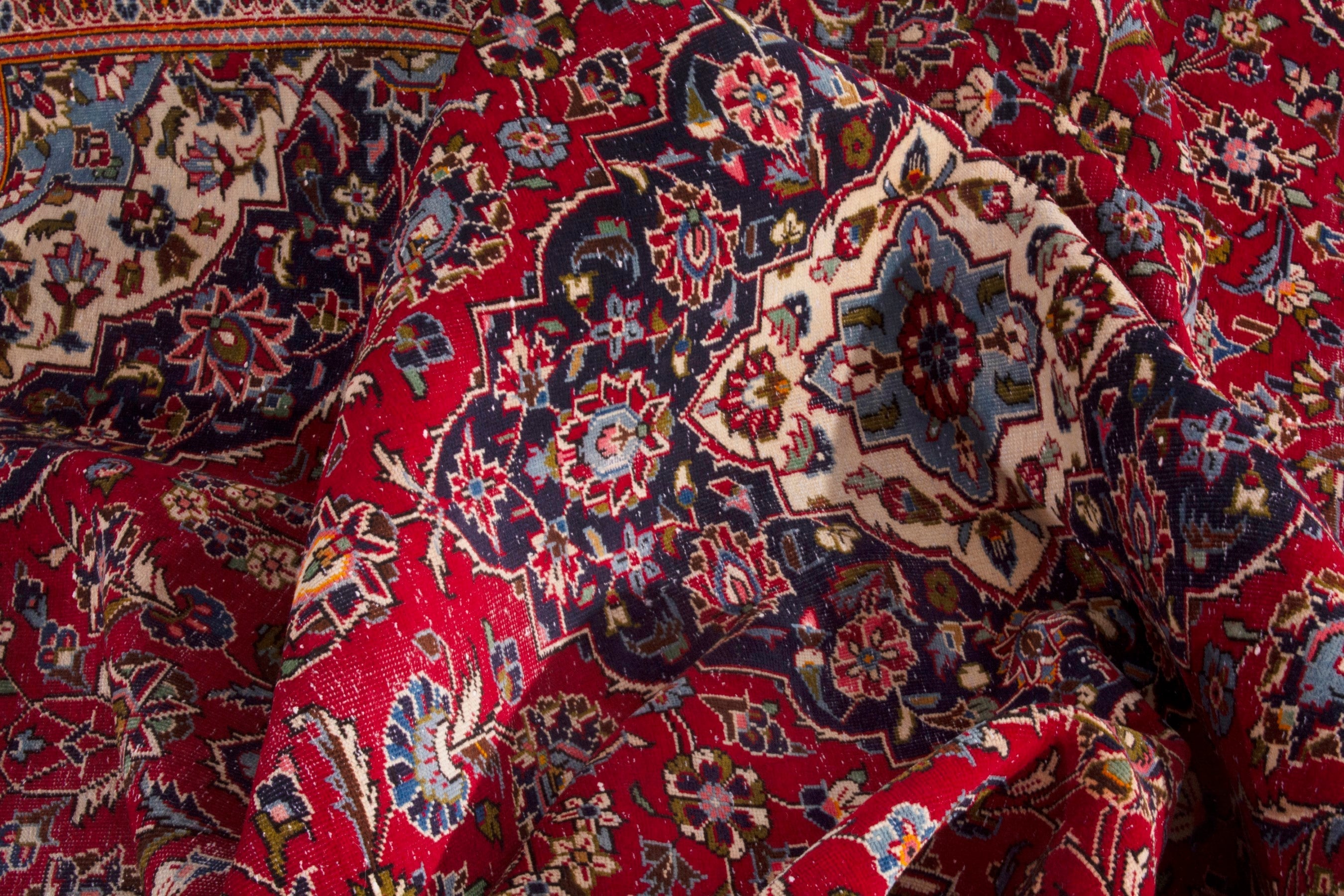 Persian Kashan oversized rug in deep red and navy, view 18 of 20