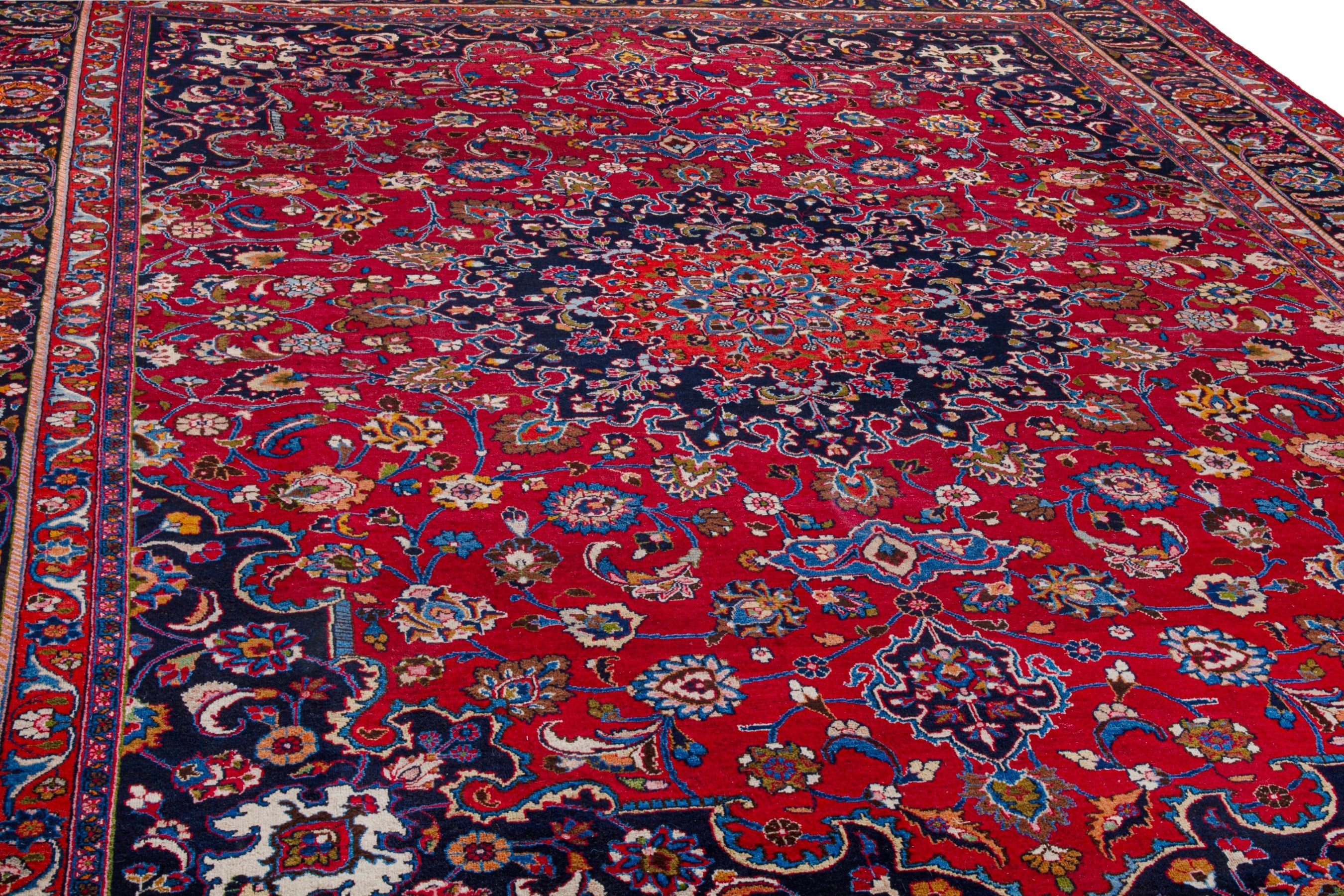 Persian Mashhad oversized rug in deep red and dark blue, view 9 of 22