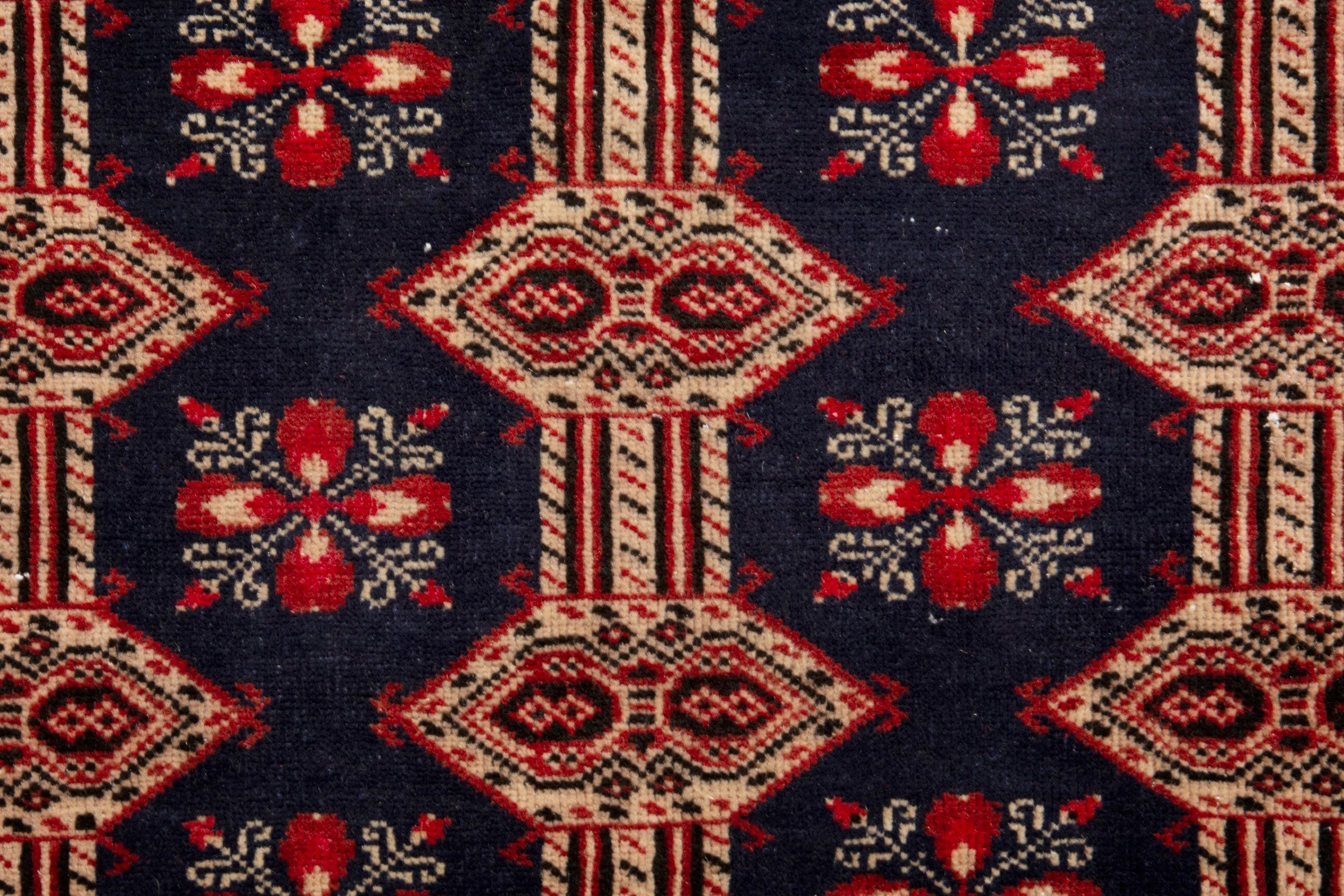 Persian Torkaman accent rug in navy and rust, view 14 of 19